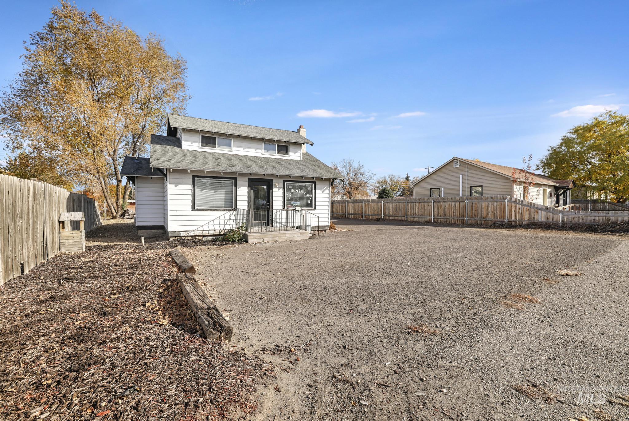 View of front of property with a chimney and a shingled roof