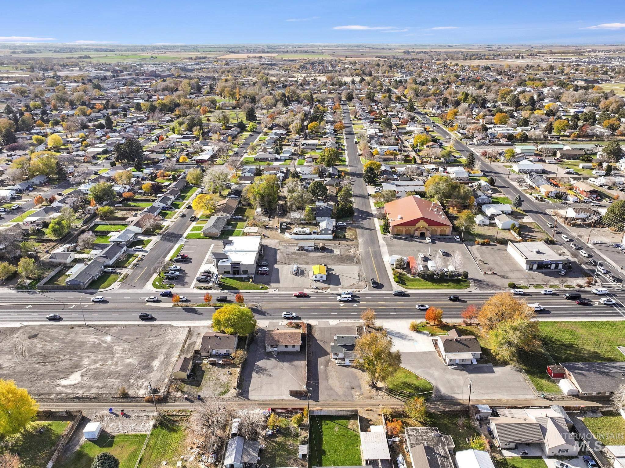 Aerial view of property's location with nearby suburban area