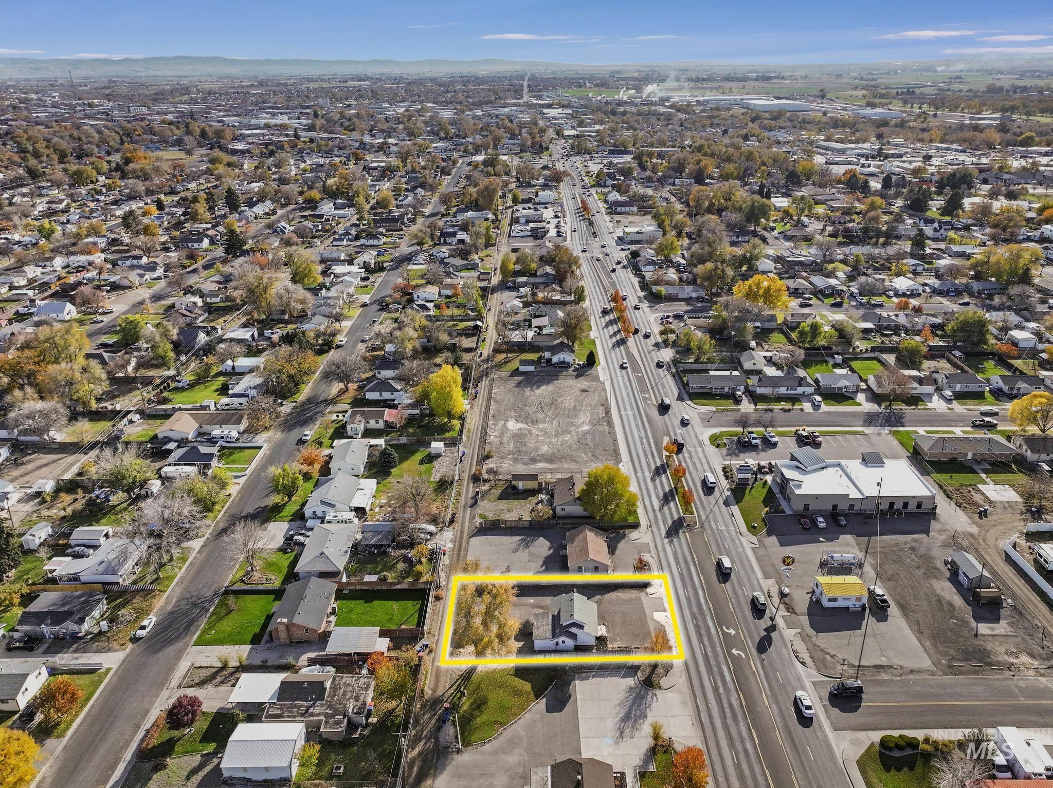 Aerial overview of property's location featuring property parcel outlined and nearby suburban area