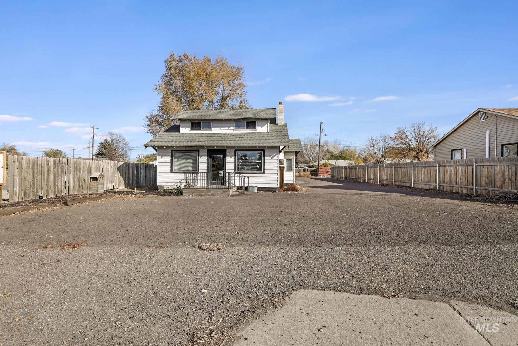 Bungalow-style home with a chimney and roof with shingles