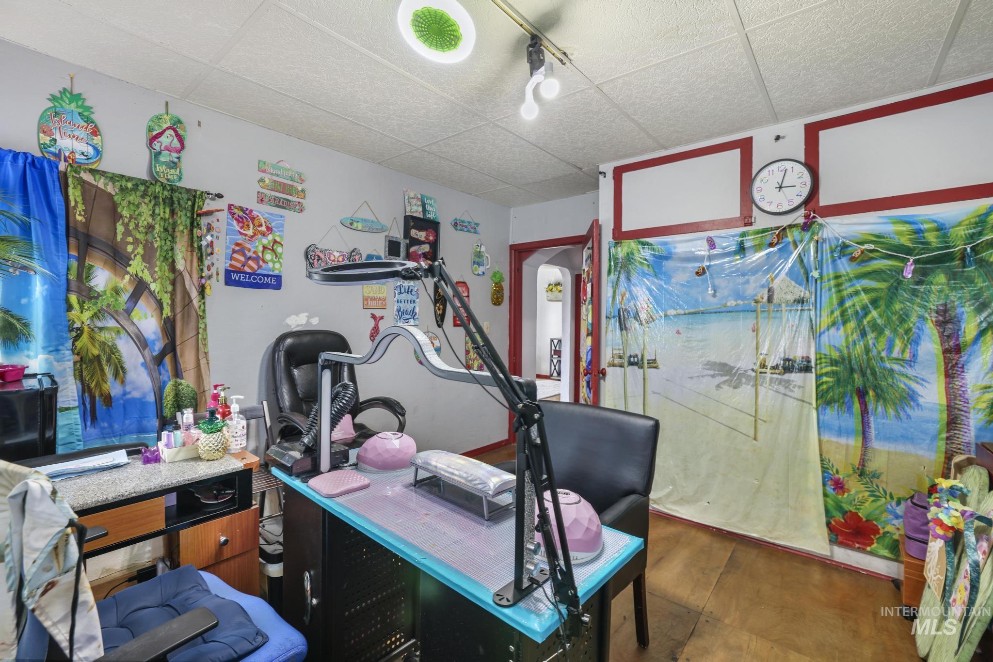 Office space featuring a drop ceiling and hardwood / wood-style flooring