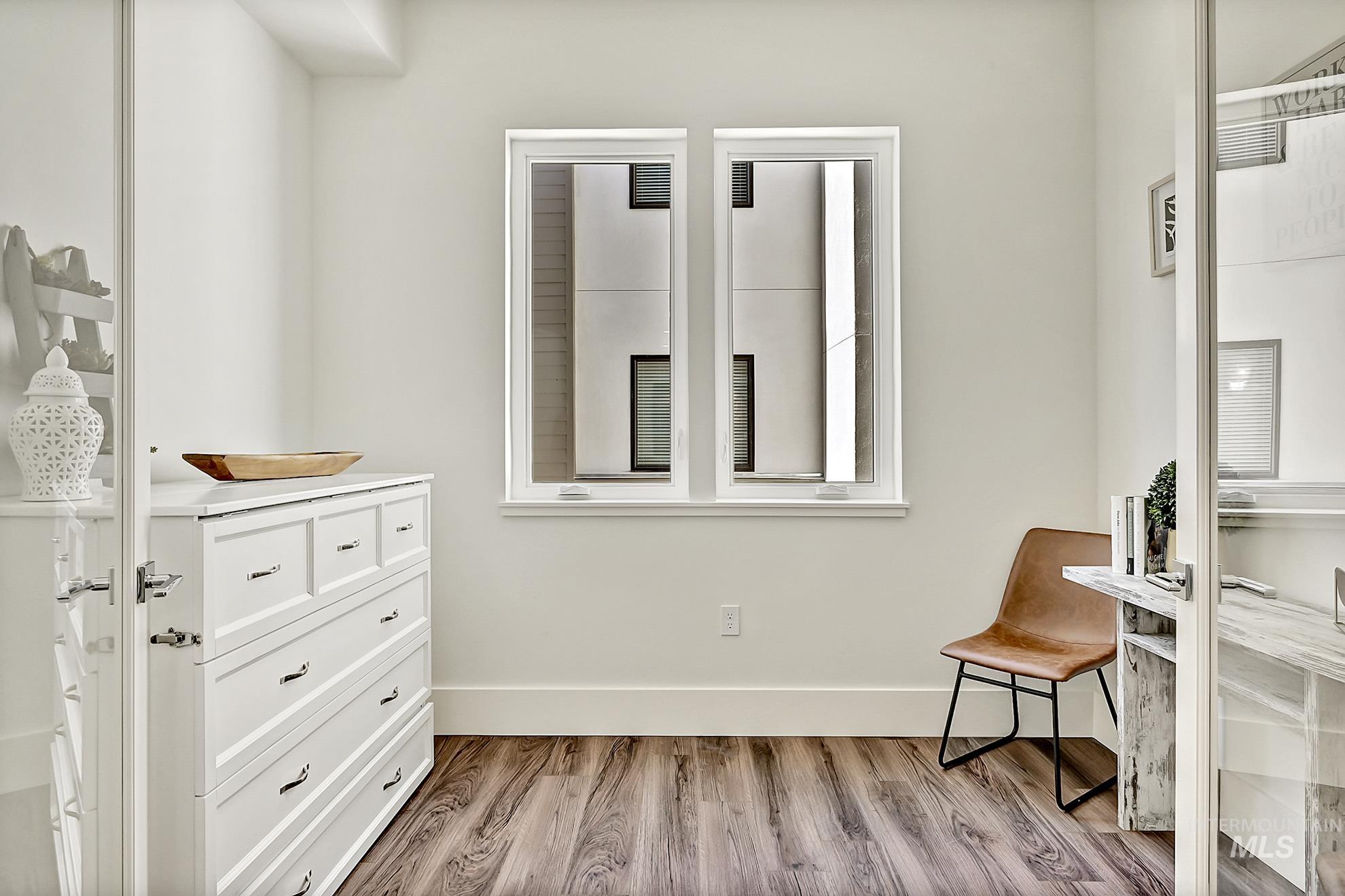 Bedroom with light wood-style floors and baseboards