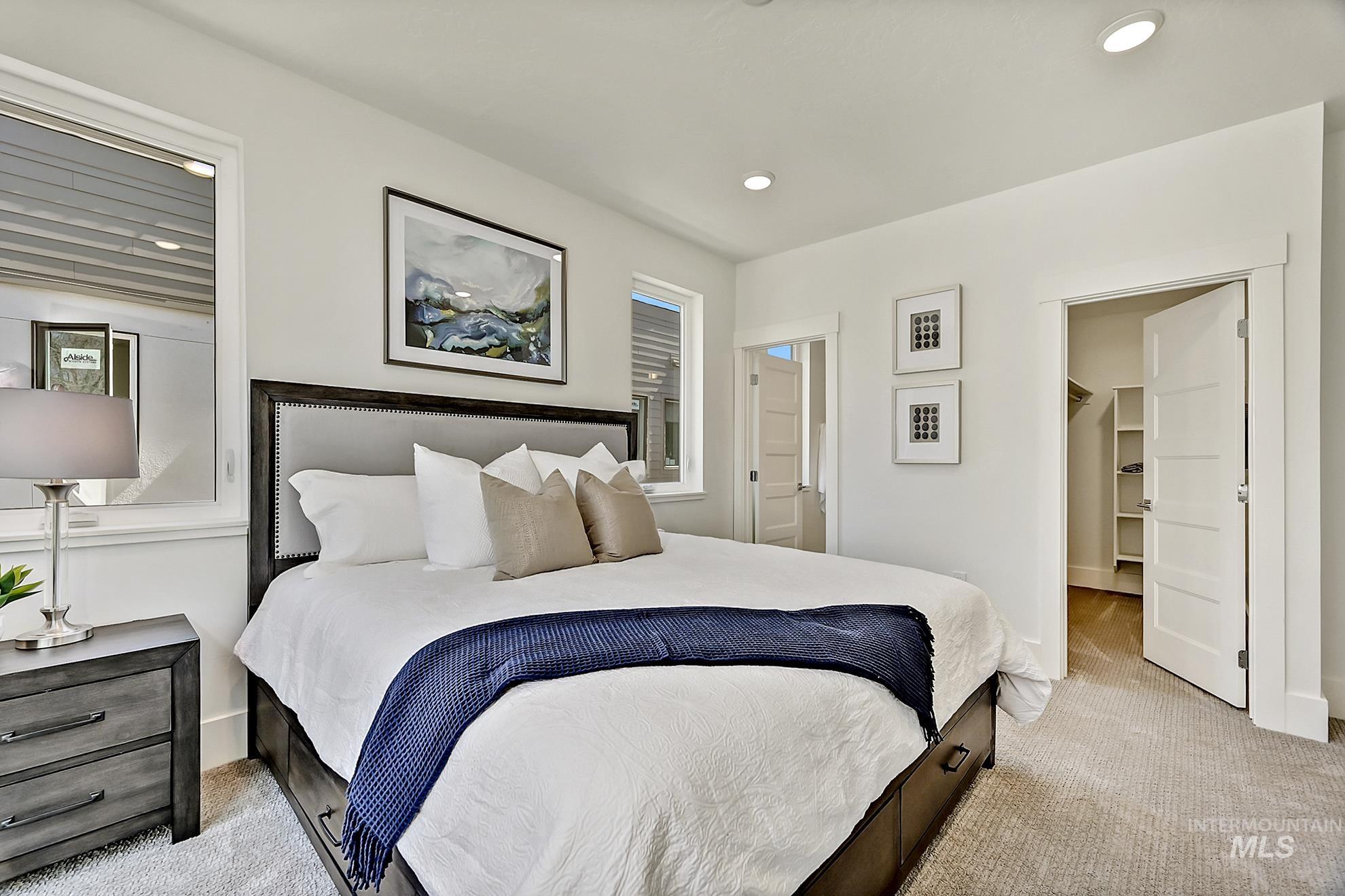 Bedroom featuring carpet, a spacious closet, and recessed lighting