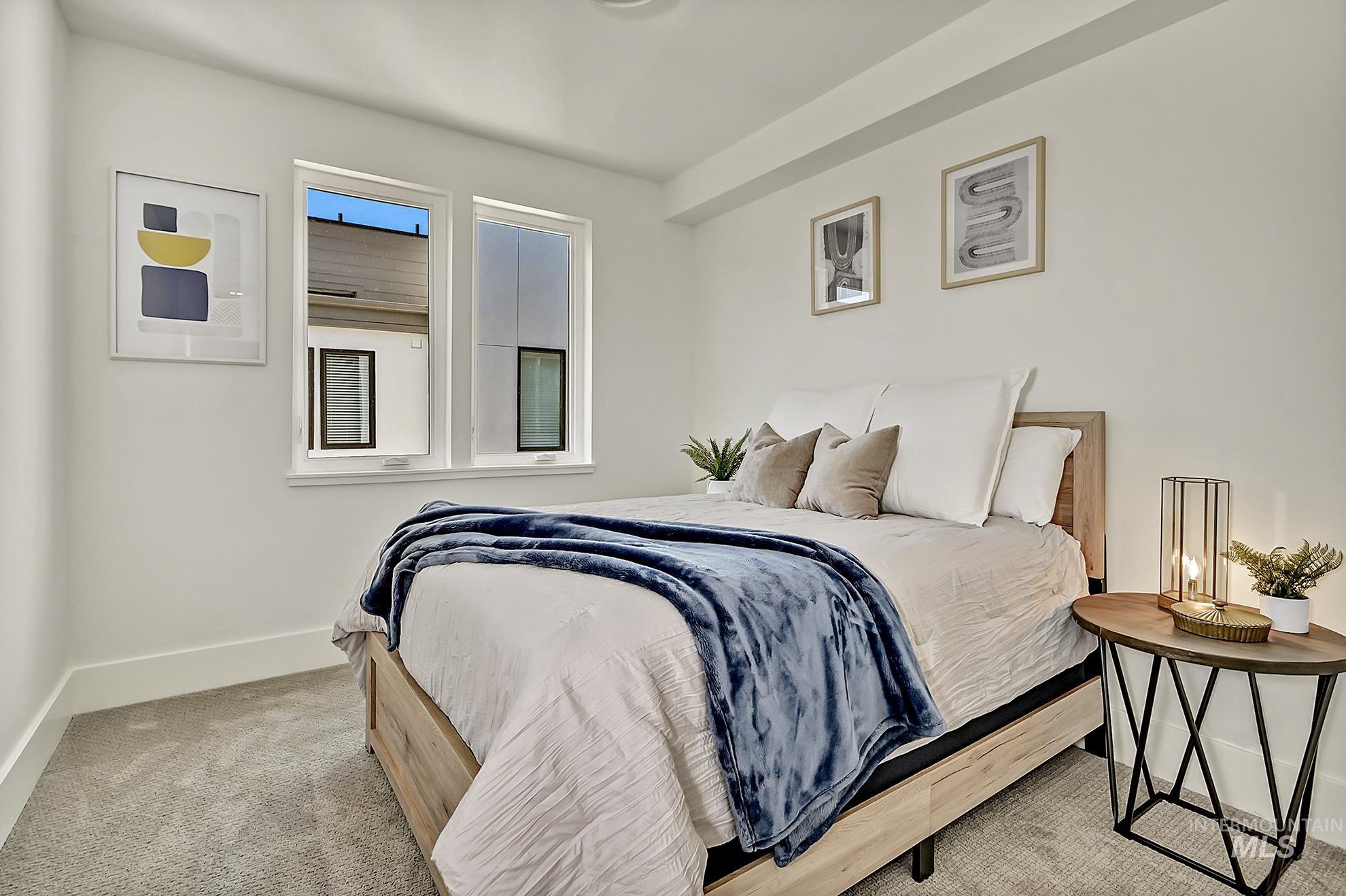 Bedroom featuring carpet floors and baseboards