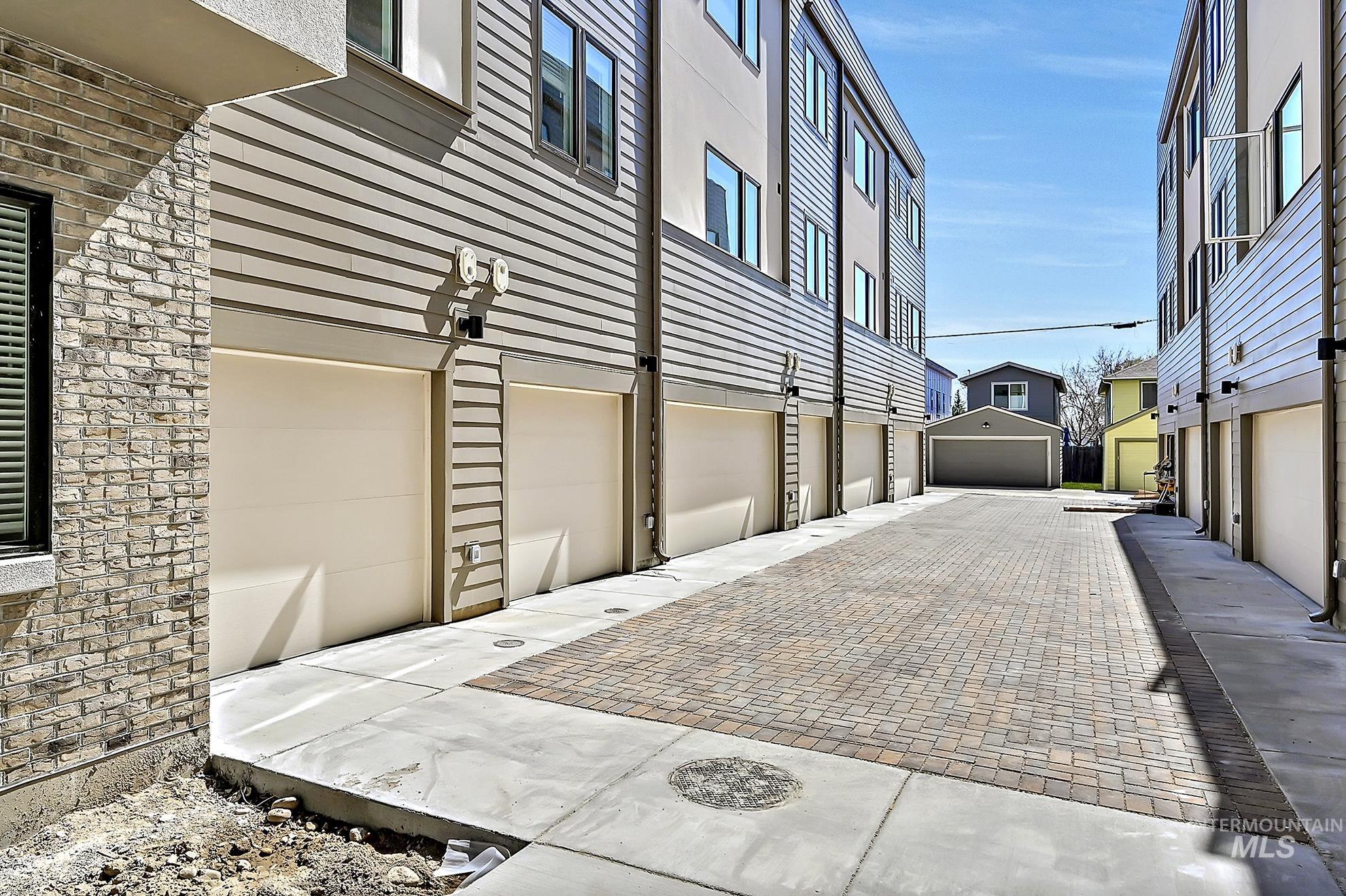 View of home's exterior featuring a garage and decorative driveway