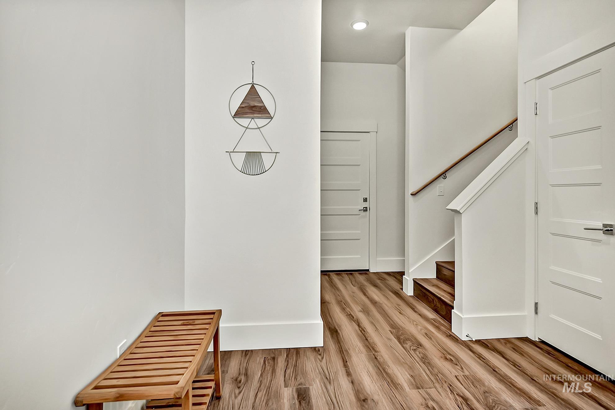Entryway with stairway and light wood-style floors