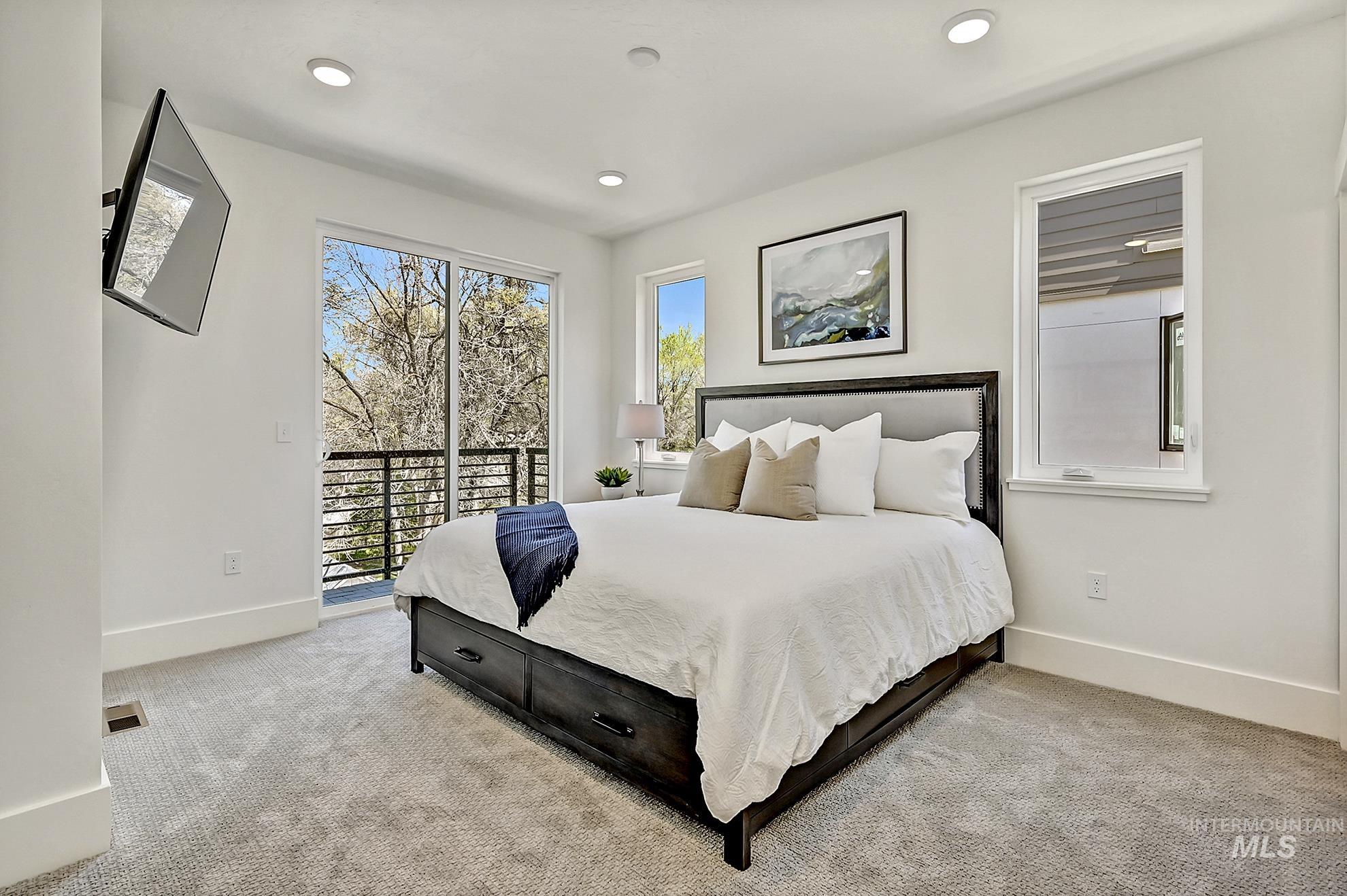 Bedroom featuring light carpet and access to exterior