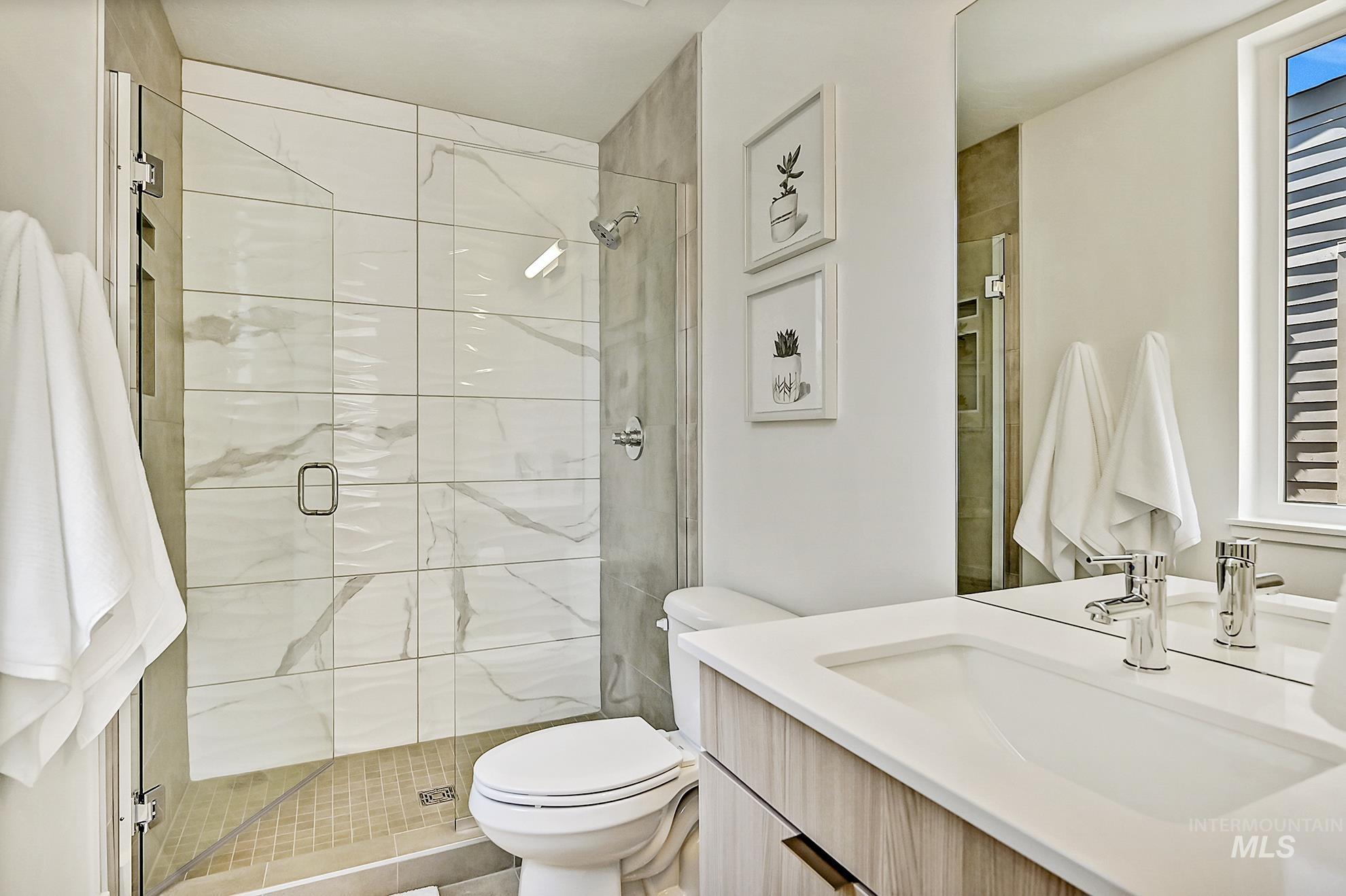 Full bath with vanity and a shower stall