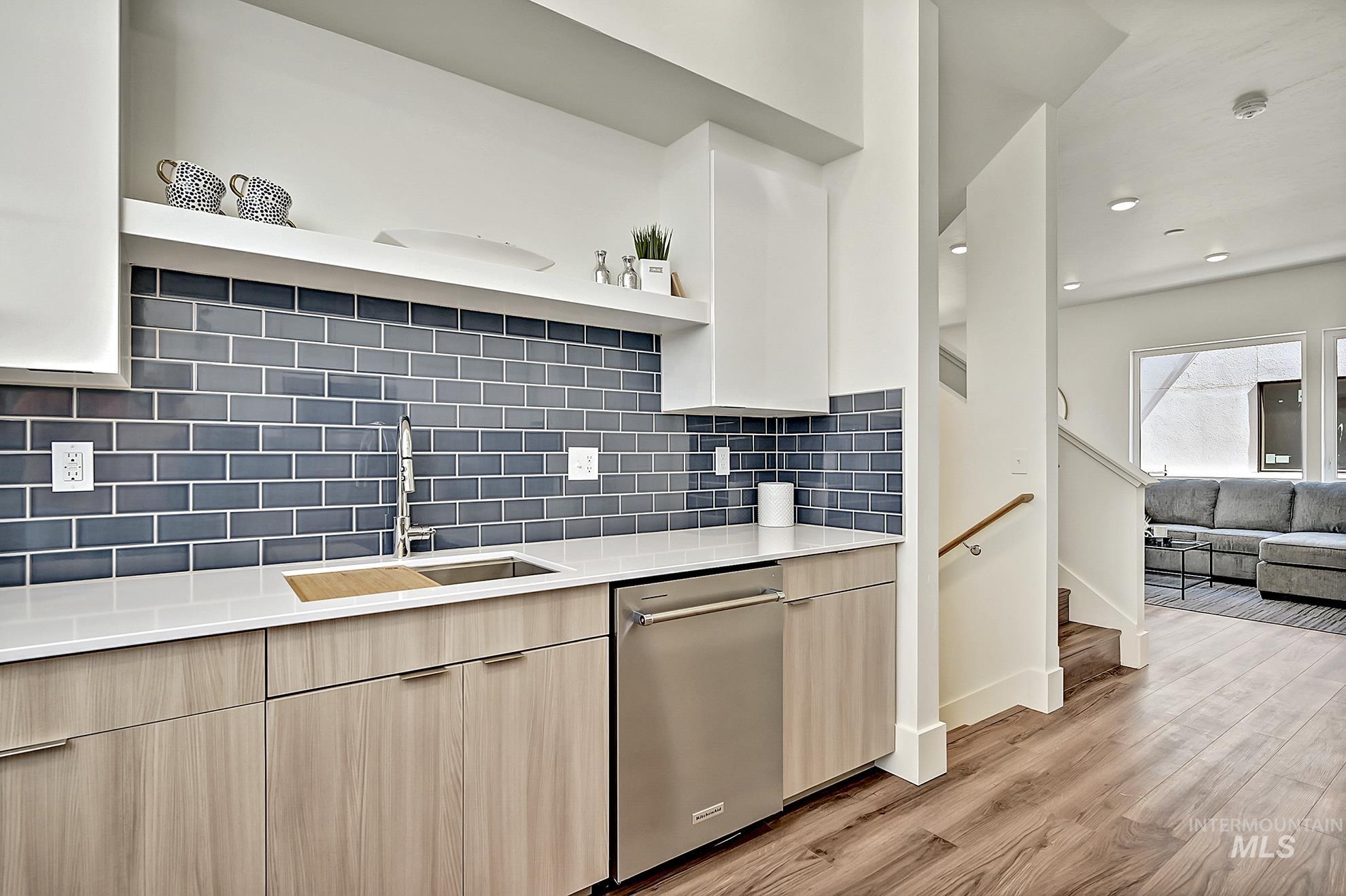 Kitchen featuring open shelves, light brown cabinets, dishwasher, quartz counters, and recessed lighting