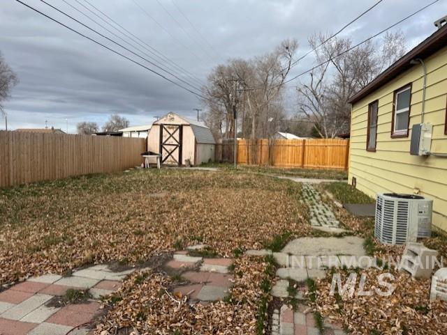 Fenced backyard with a storage unit