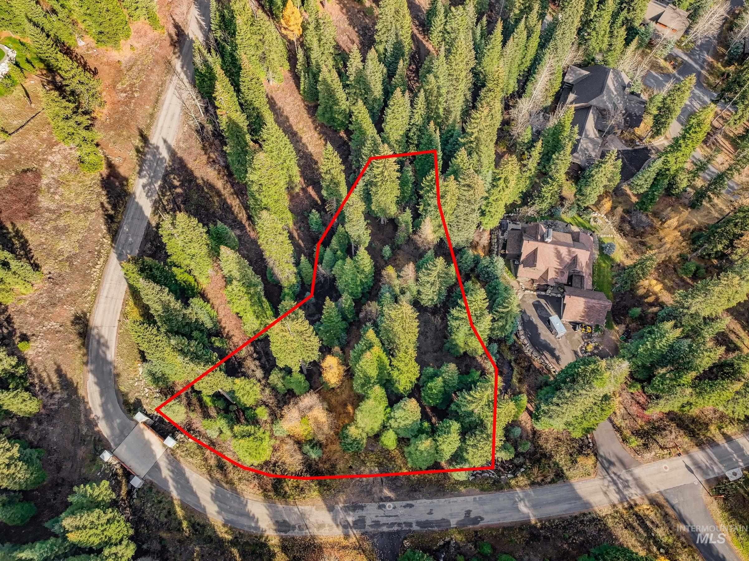 Aerial overview of property's location with property boundaries highlighted and a large body of water