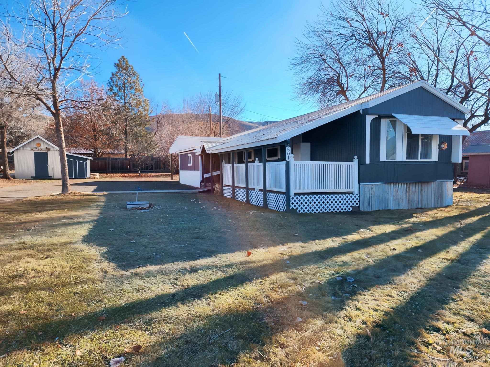 Charming single-level home with a welcoming covered porch, crisp exterior updates, and a spacious yard with mature trees. Plenty of room for outdoor living, gardening, or future improvements. Clean, bright, and move-in ready.