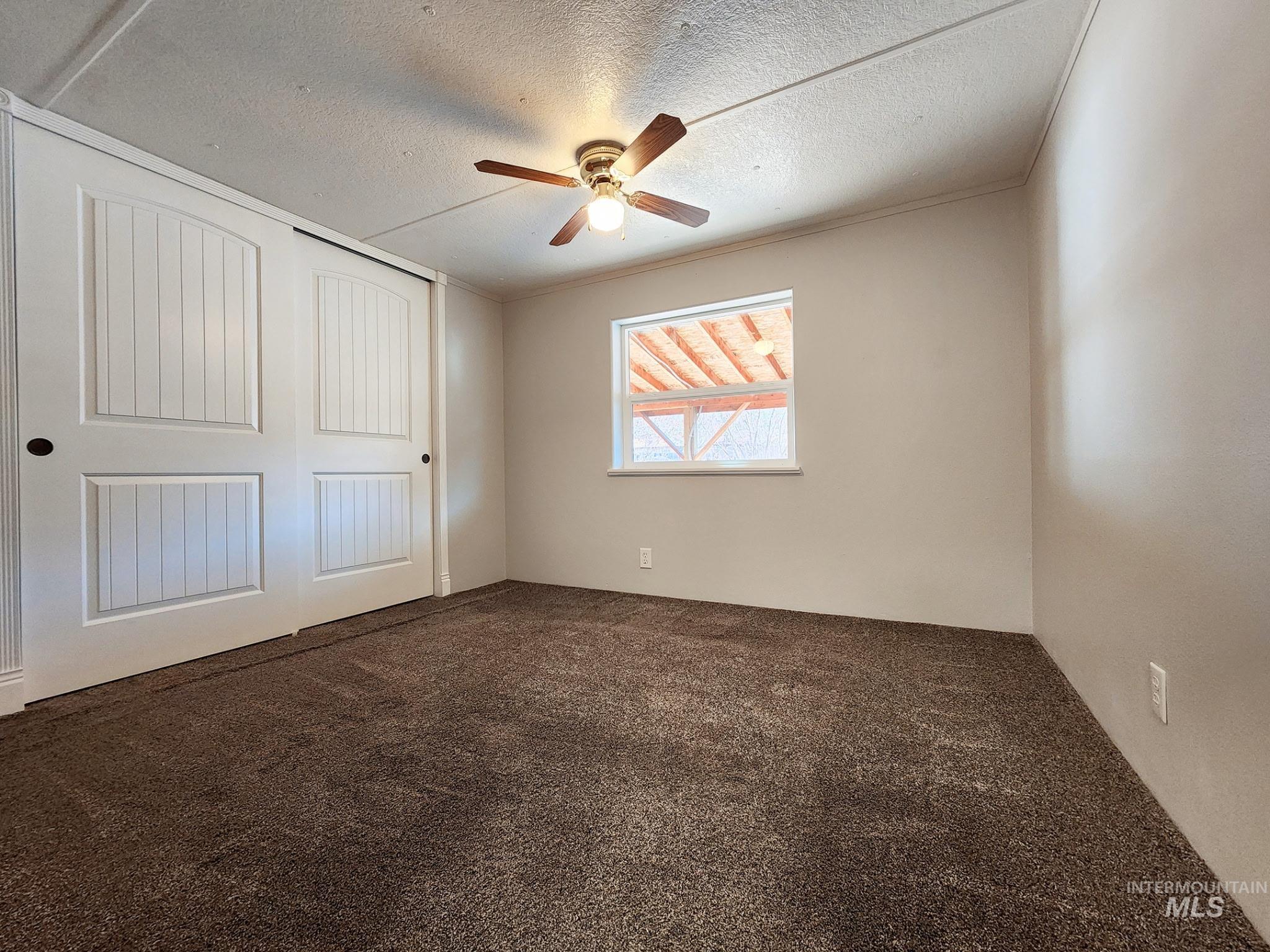 Cozy bedroom with fresh paint and a bright window that brings in natural light. Double-door closet offers great storage, and the ceiling fan adds year-round comfort. Clean, move-in-ready space.