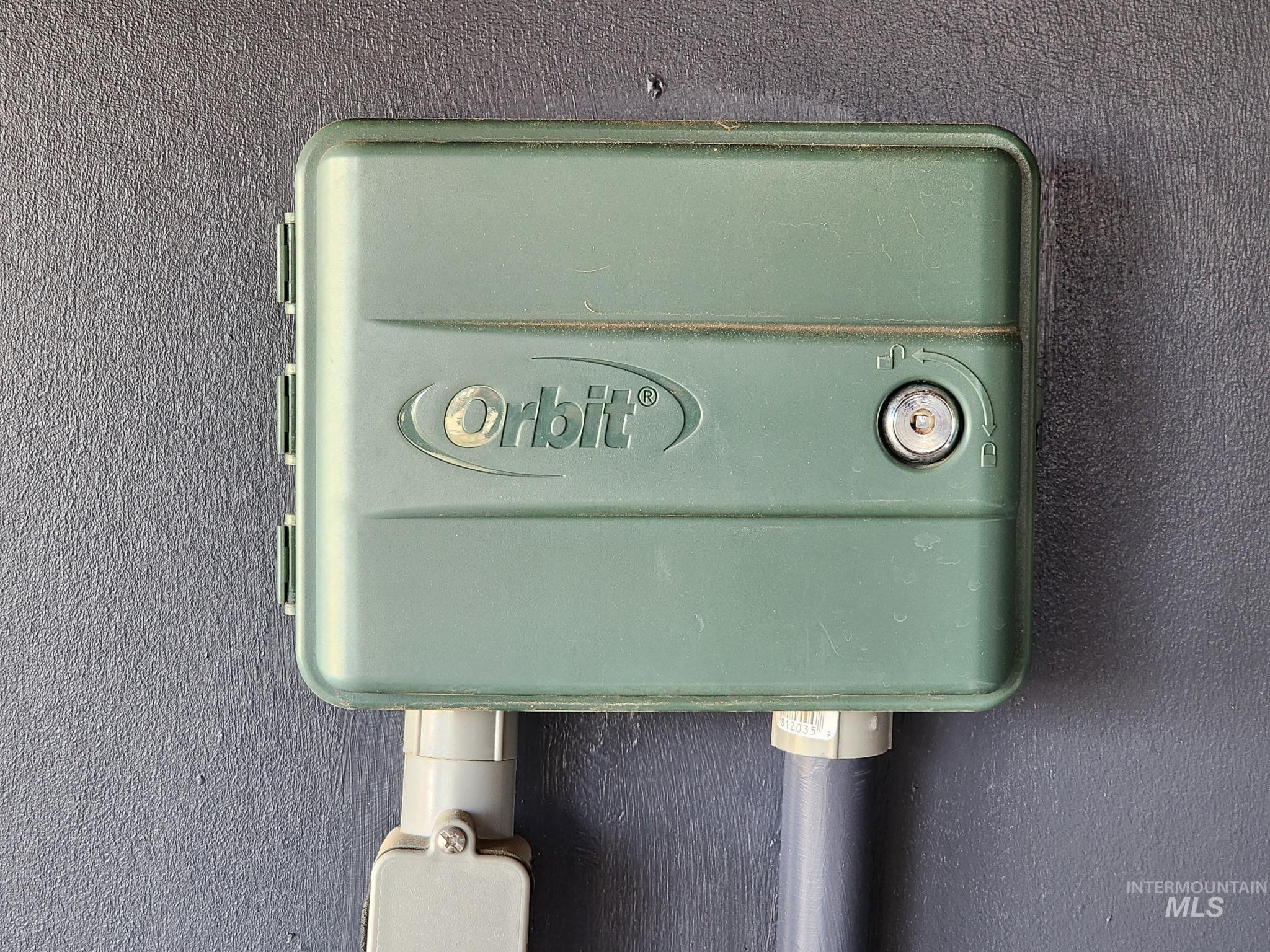 Home features an automatic sprinkler system with a dedicated control box for easy lawn and garden care. A great low-maintenance upgrade that keeps the yard healthy and green.