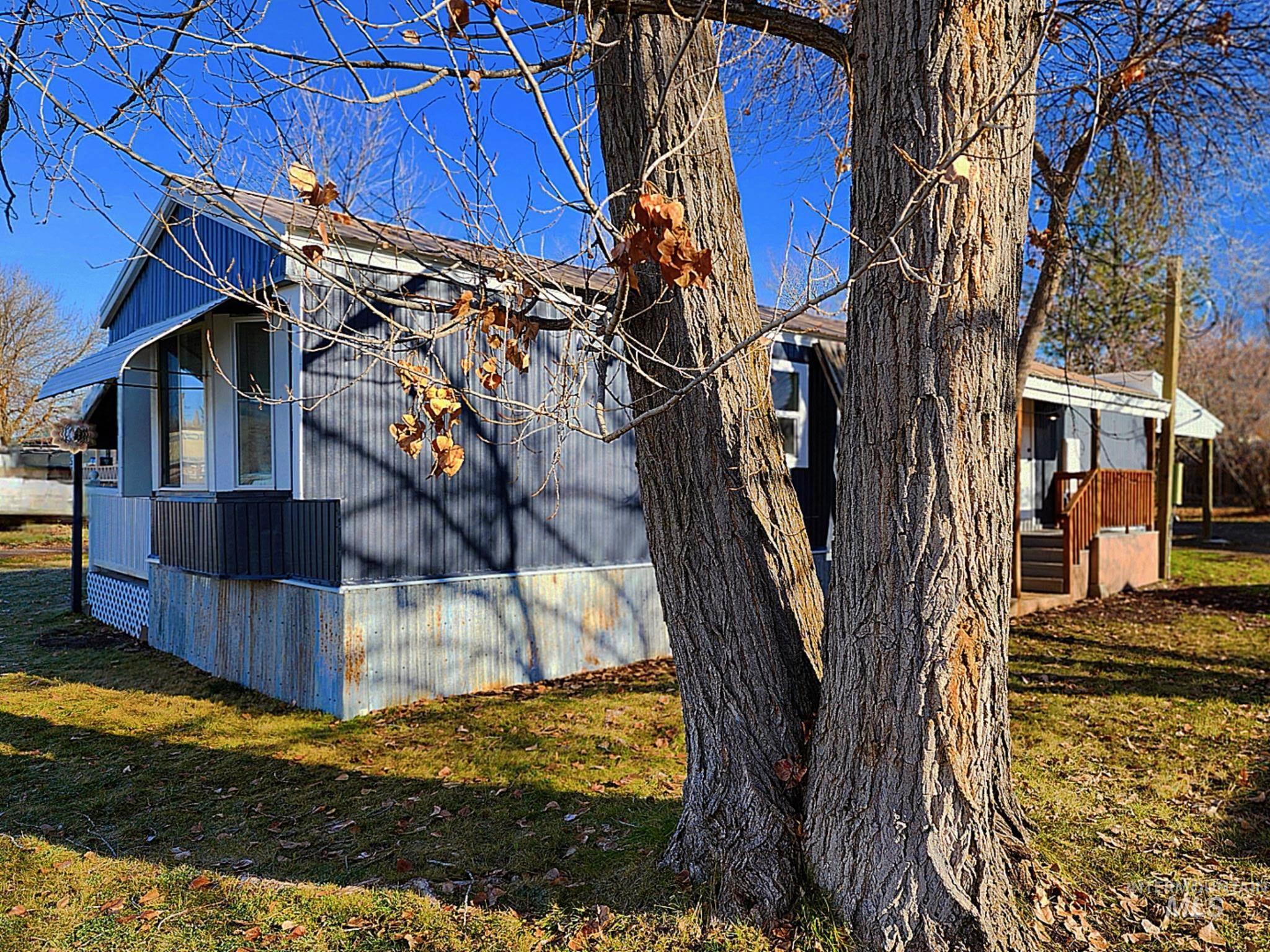 Inviting exterior with fresh paint, mature trees, and a spacious yard that adds privacy and charm. Clean lines and natural light enhance the home’s curb appeal—great setting for Idaho living.