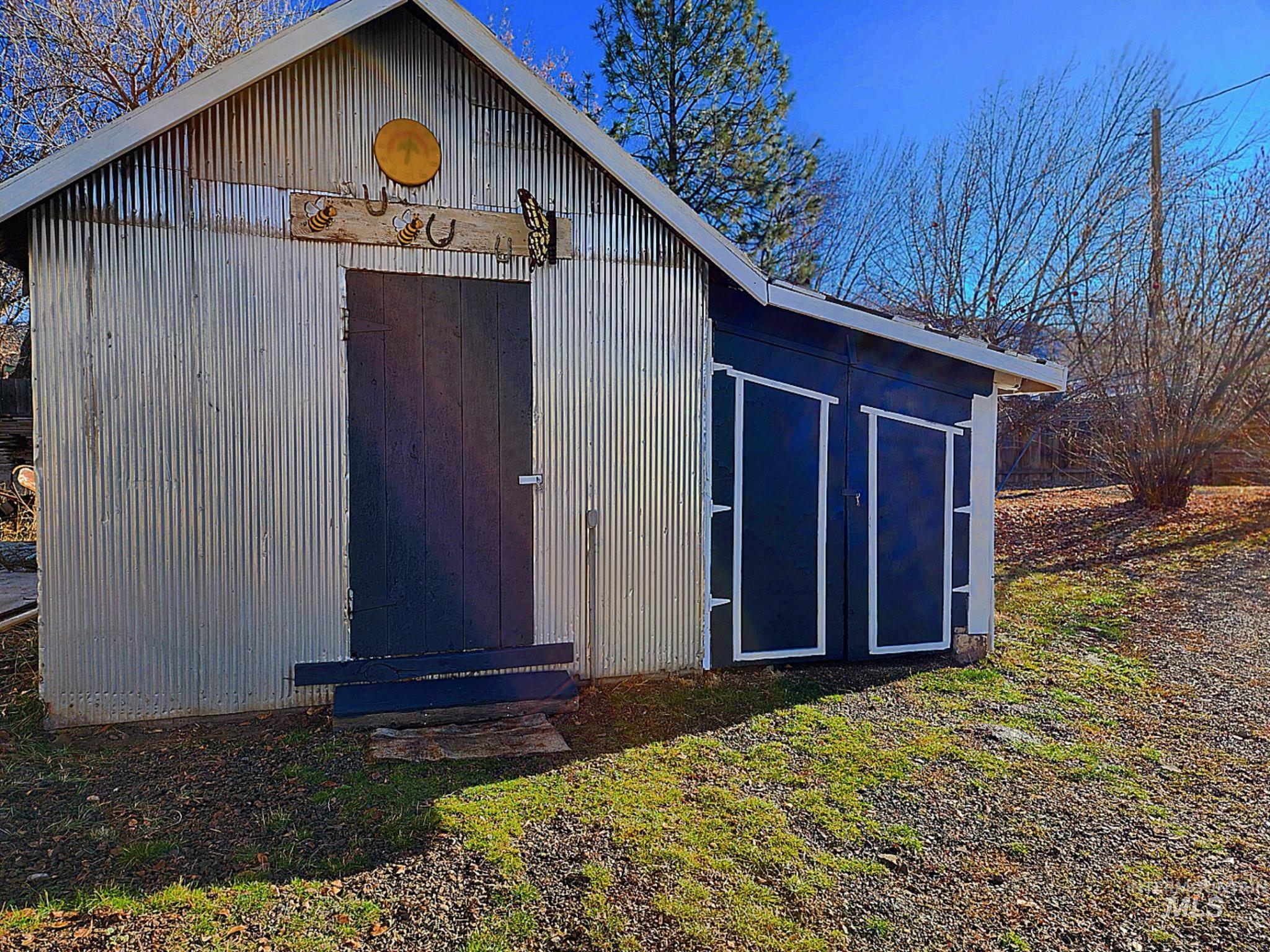 Great storage shed with multiple access doors, perfect for tools, lawn equipment, or hobby space. Positioned on a roomy lot with mature trees and open yard. A useful bonus for Idaho homeowners.