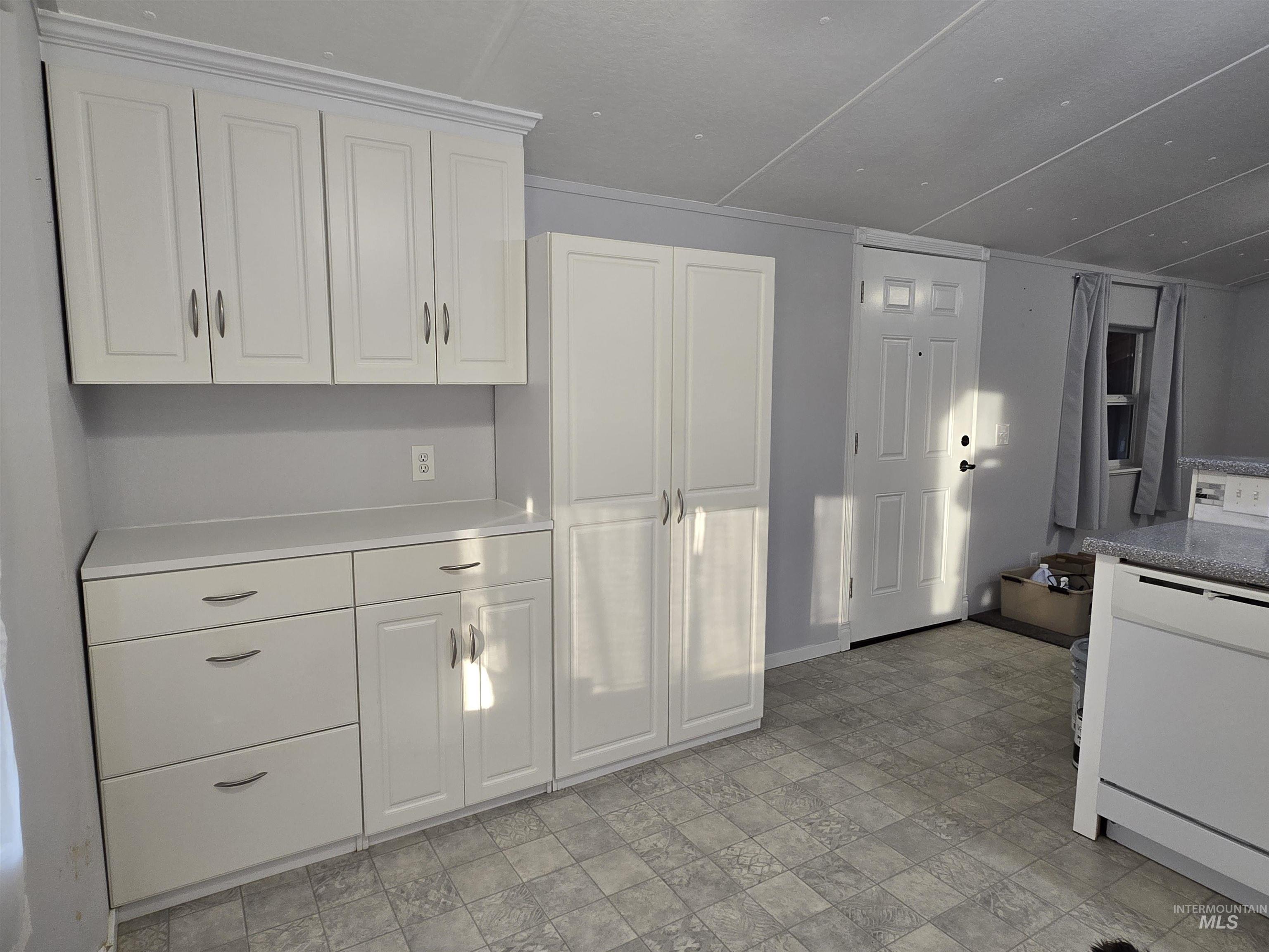 Abundant built-in storage with clean white cabinetry and bright natural light. This flexible space adds organization and functionality to the home, ideal for pantry use, linens, or everyday essentials.