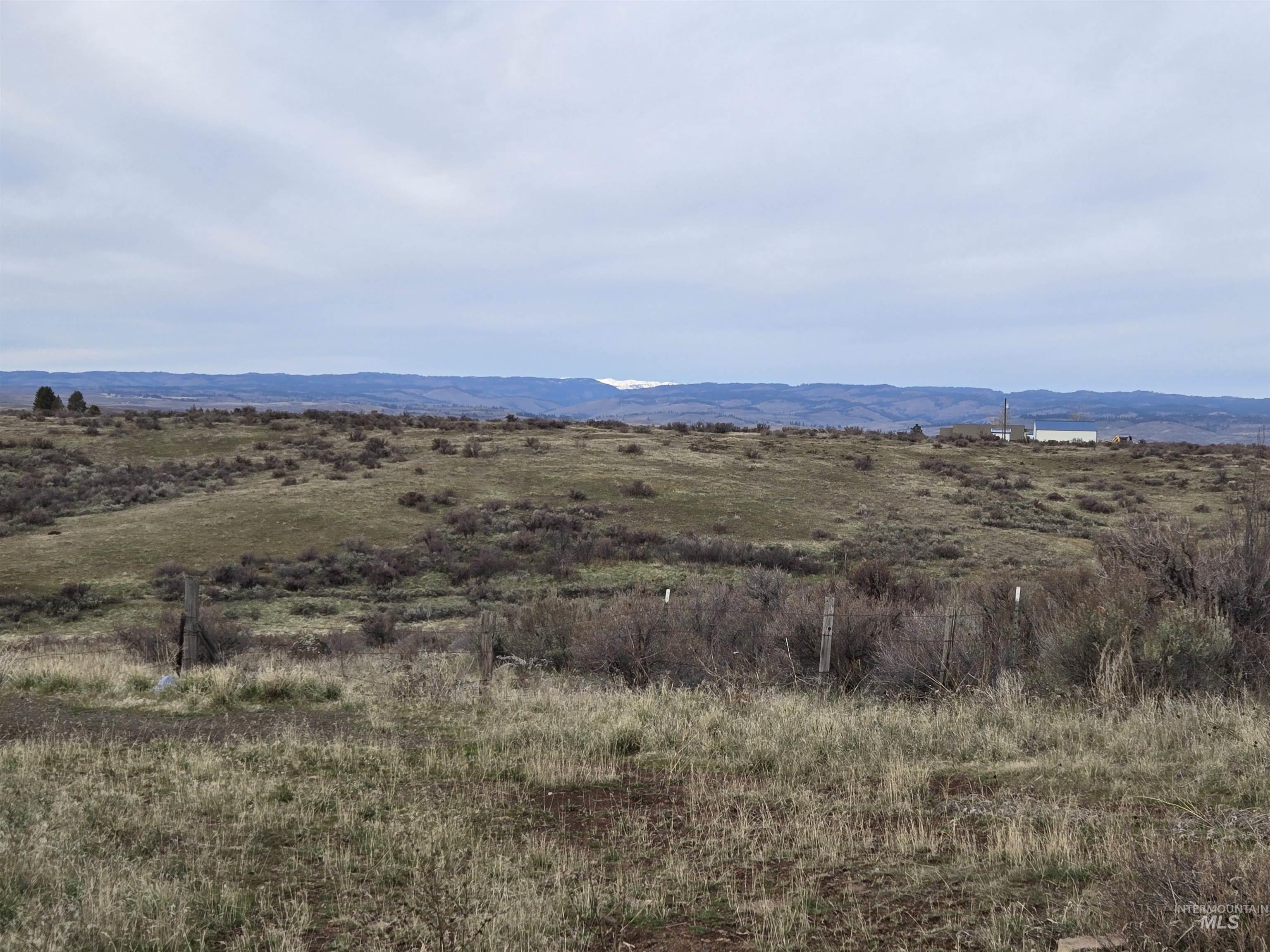 View of mountain background featuring rural landscape