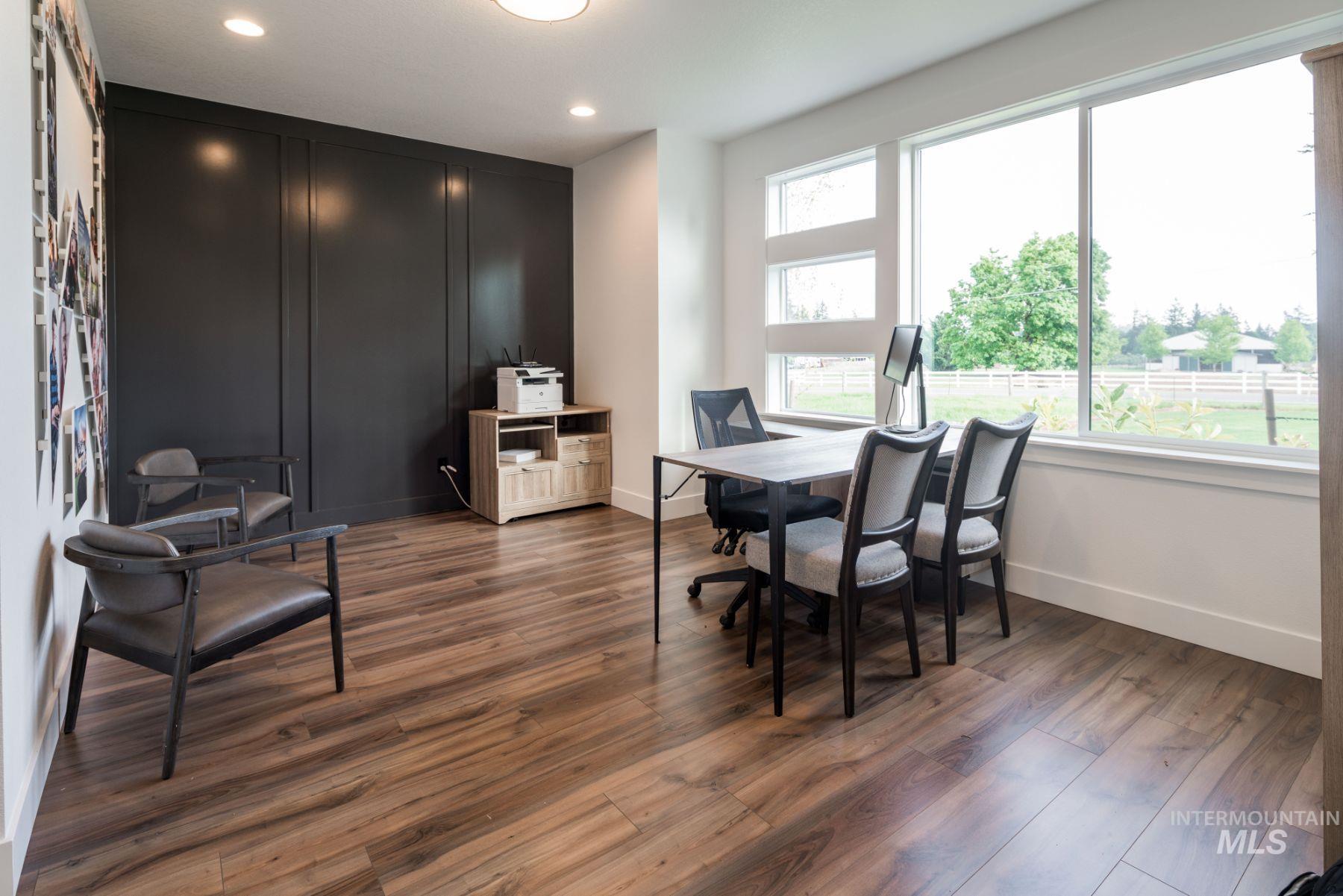 Office space with dark wood-style floors and recessed lighting
