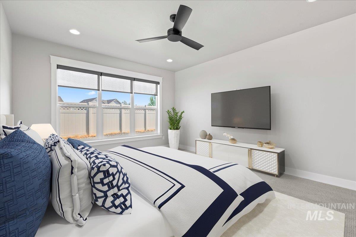 Carpeted bedroom featuring recessed lighting and a ceiling fan
