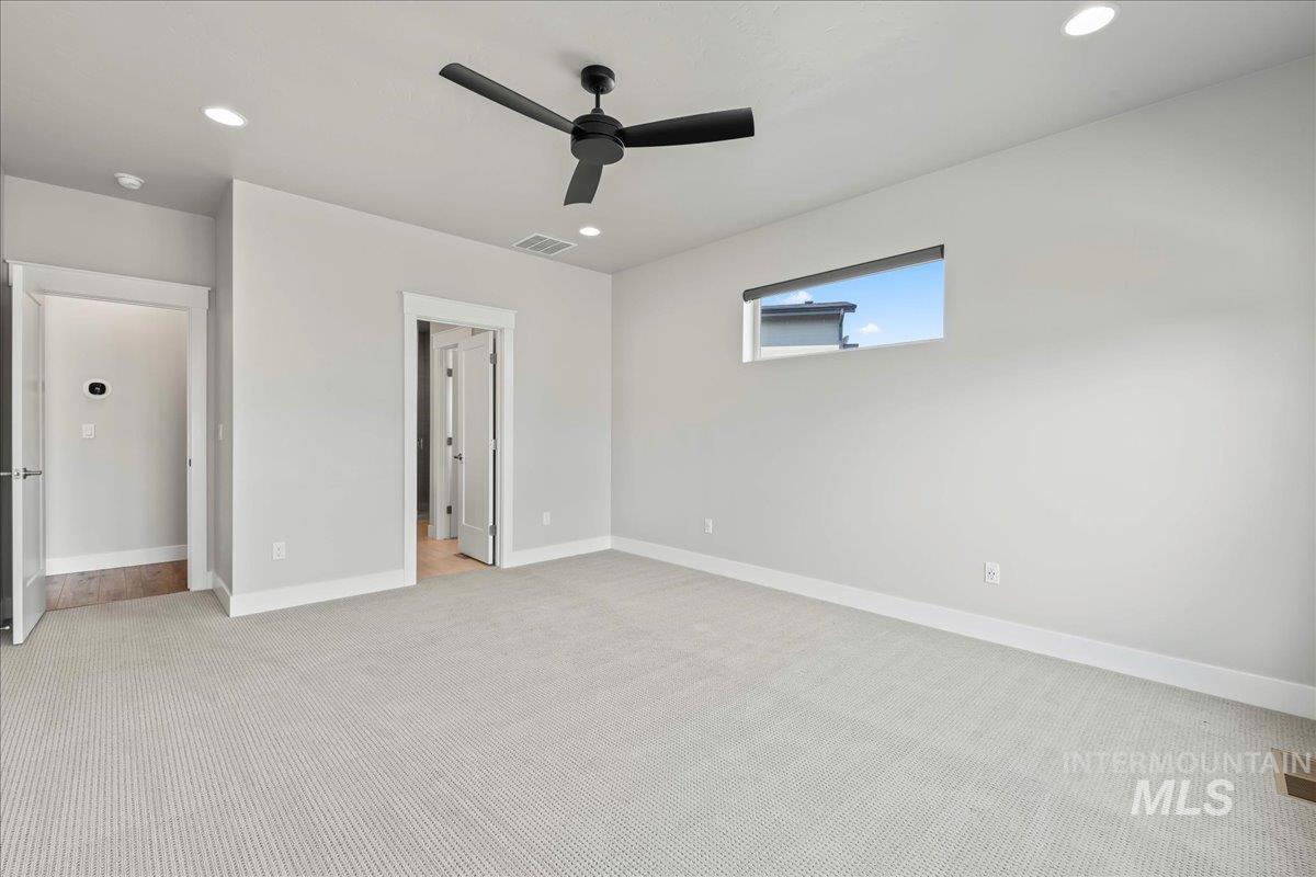 Unfurnished bedroom featuring light carpet, recessed lighting, and ceiling fan