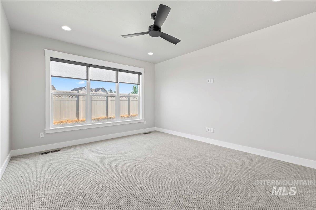 Spare room featuring carpet, recessed lighting, and ceiling fan