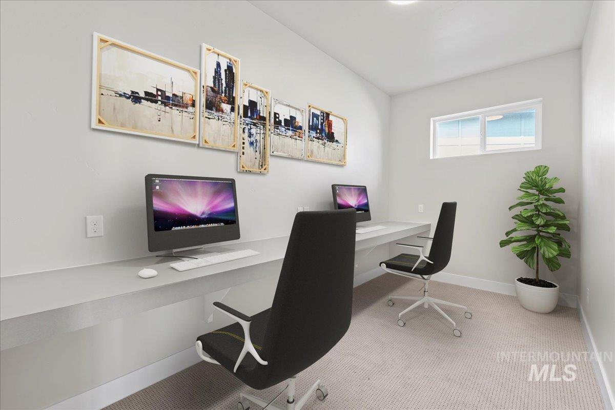 Carpeted home office with baseboards and built in desk