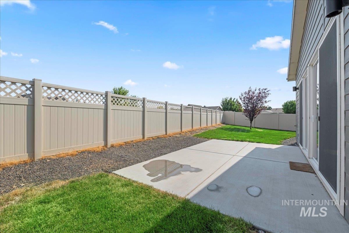 Fenced backyard featuring a patio