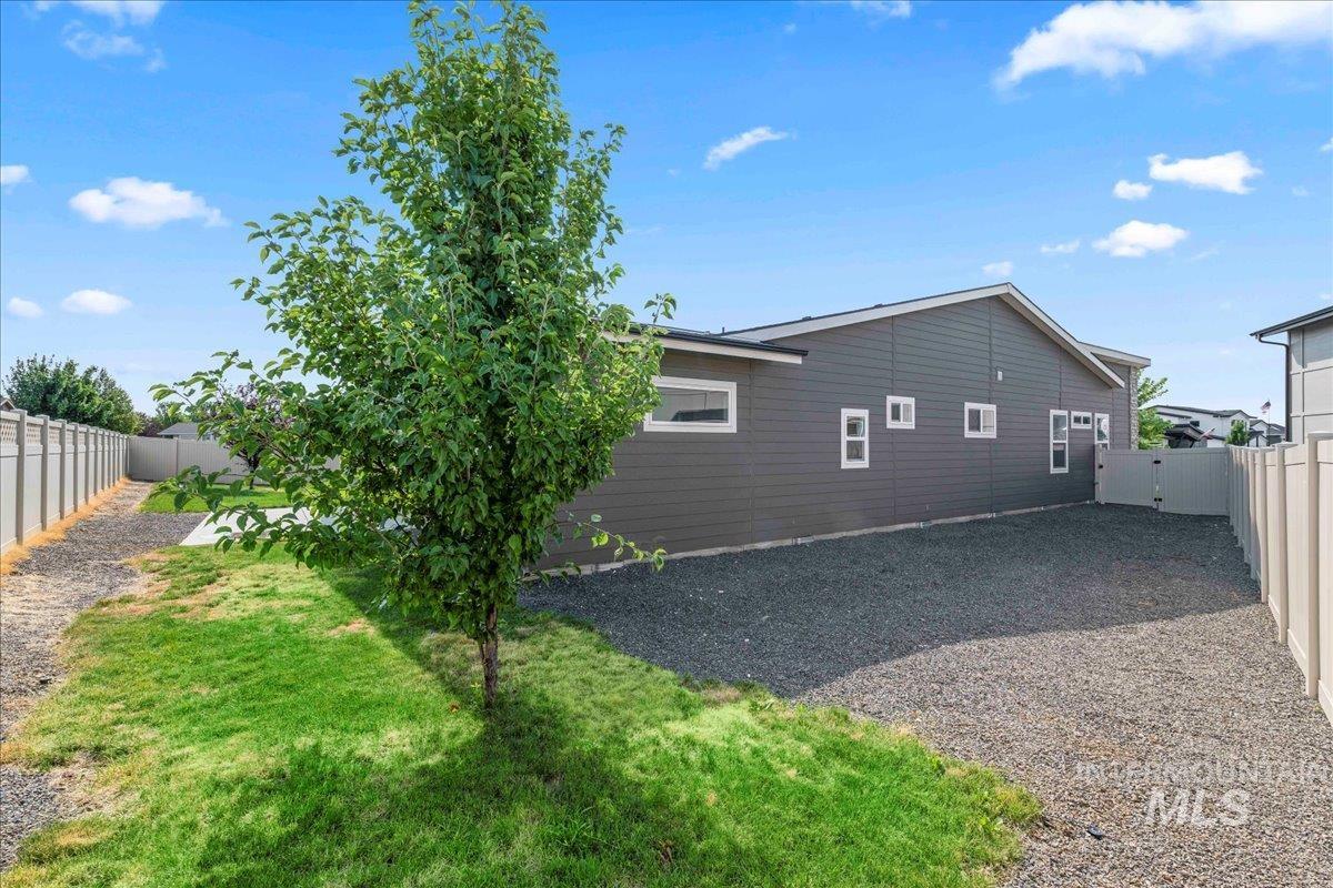 Rear view of property with a fenced backyard
