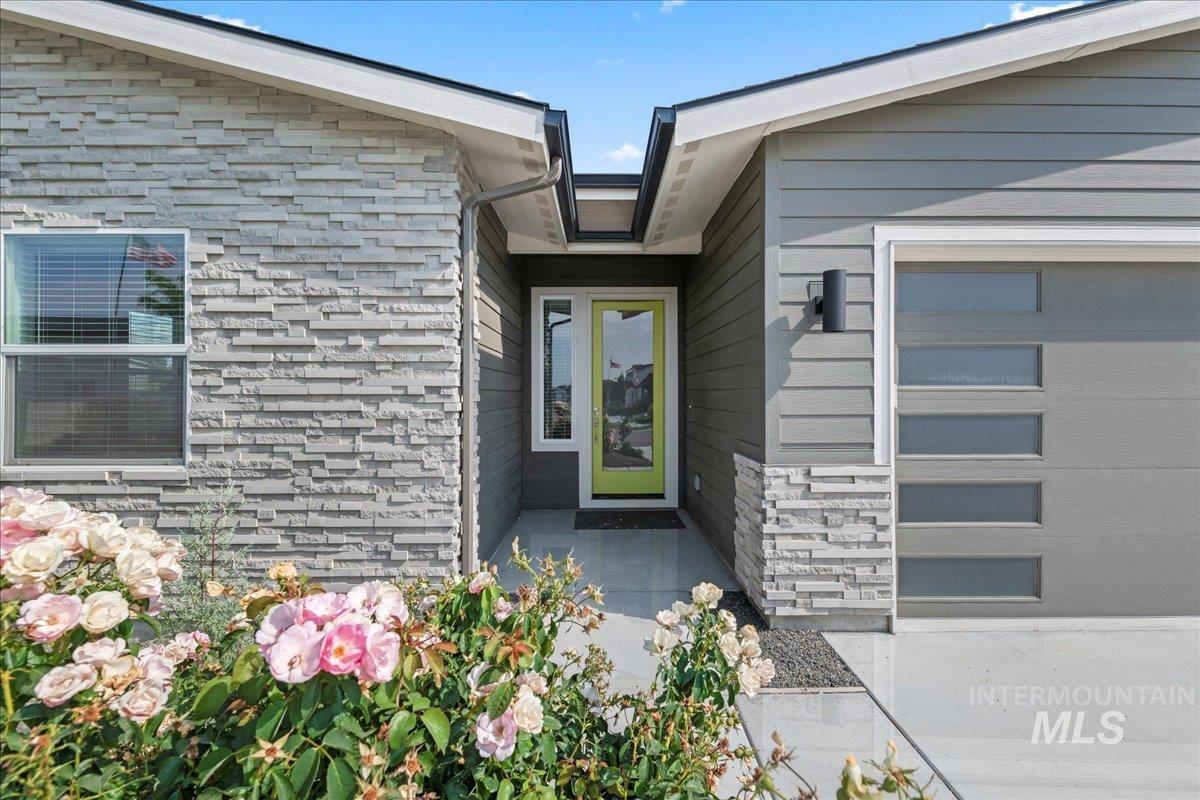 Doorway to property with stone siding
