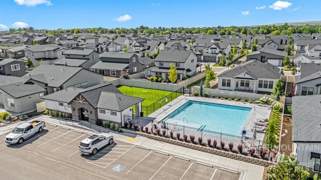 Aerial view of residential area featuring a pool