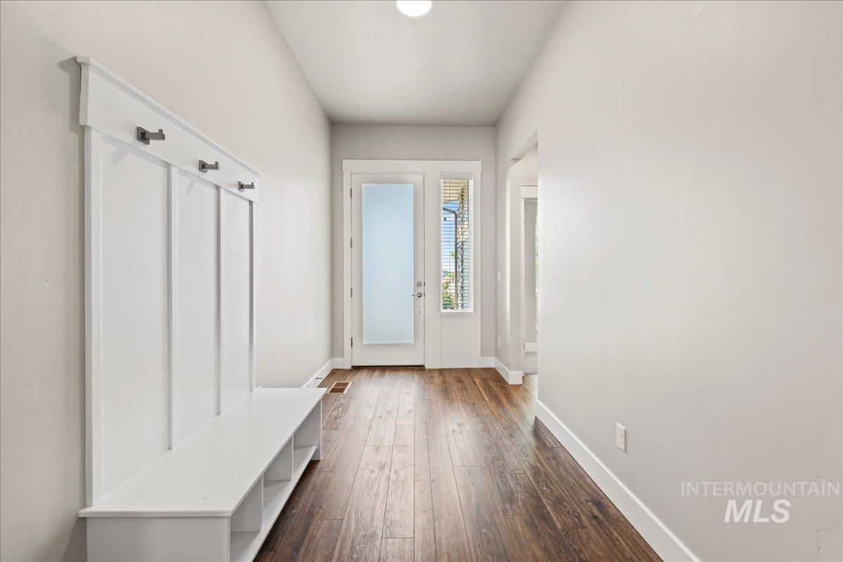 Mudroom with baseboards and dark wood-type flooring
