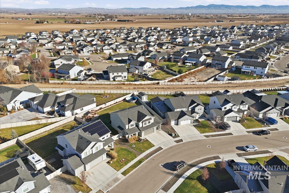 Aerial overview of property's location with nearby suburban area and a mountain backdrop