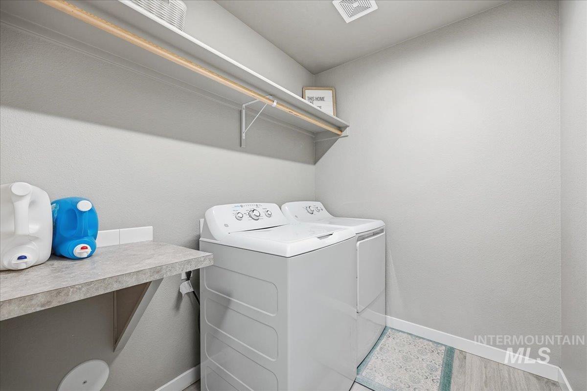 Laundry room featuring baseboards and washing machine and dryer