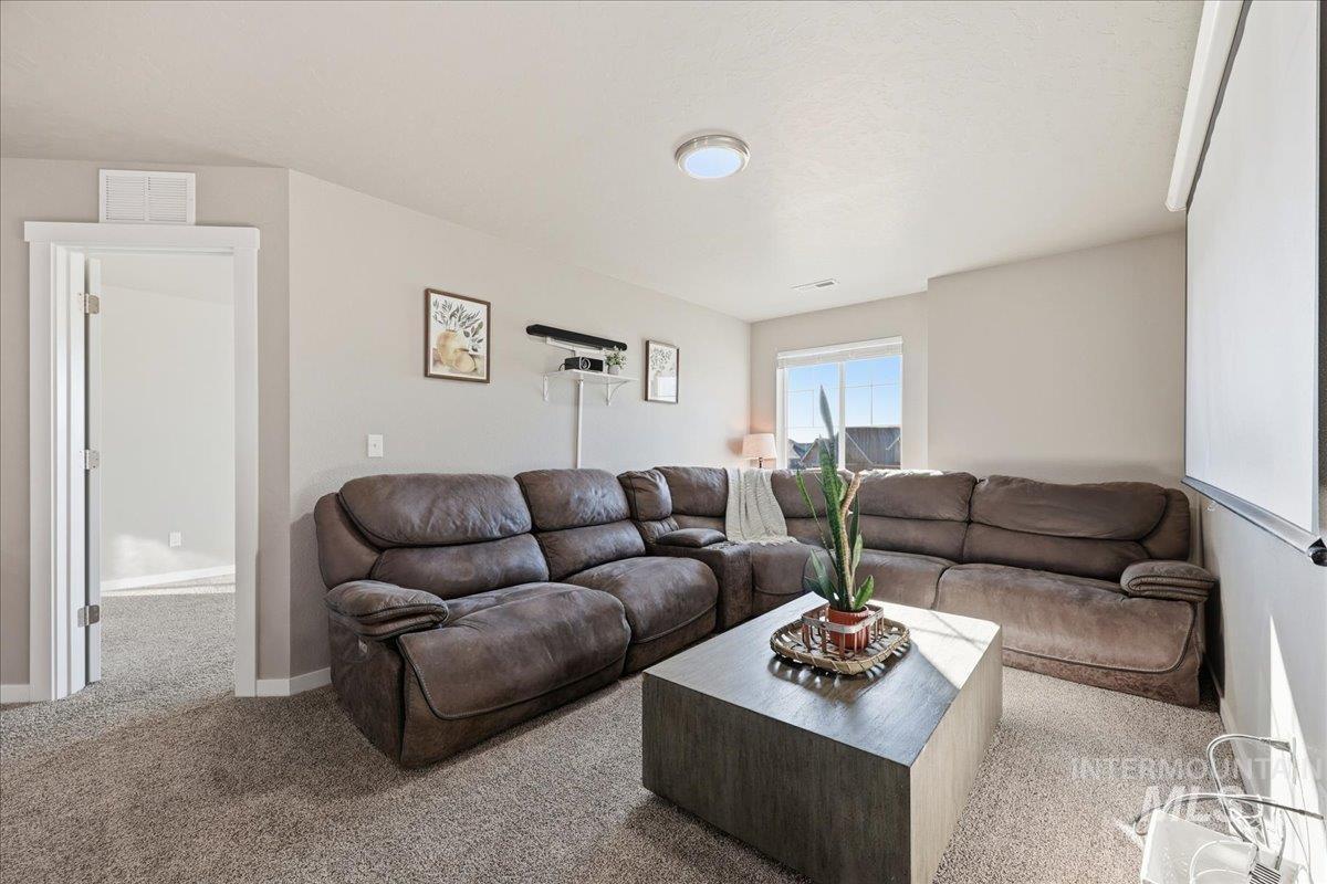 Living area featuring light carpet