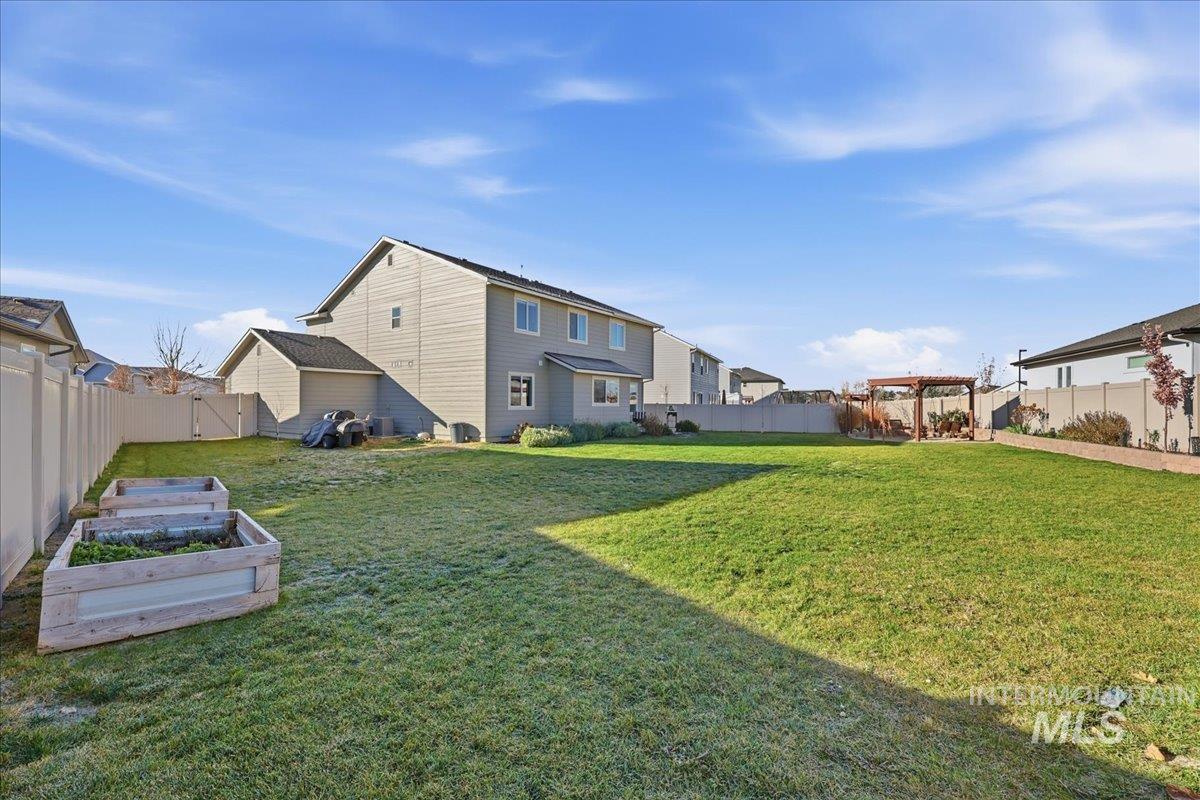 Fenced backyard featuring a garden