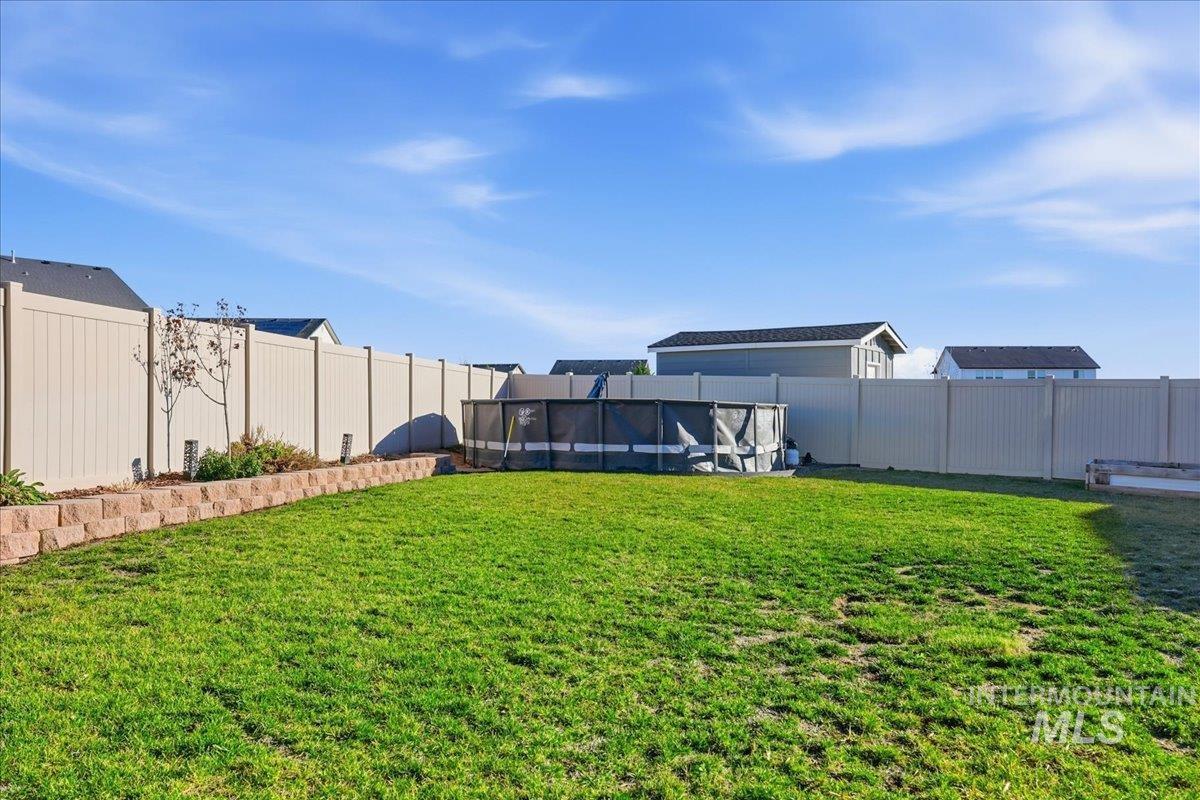 View of fenced backyard