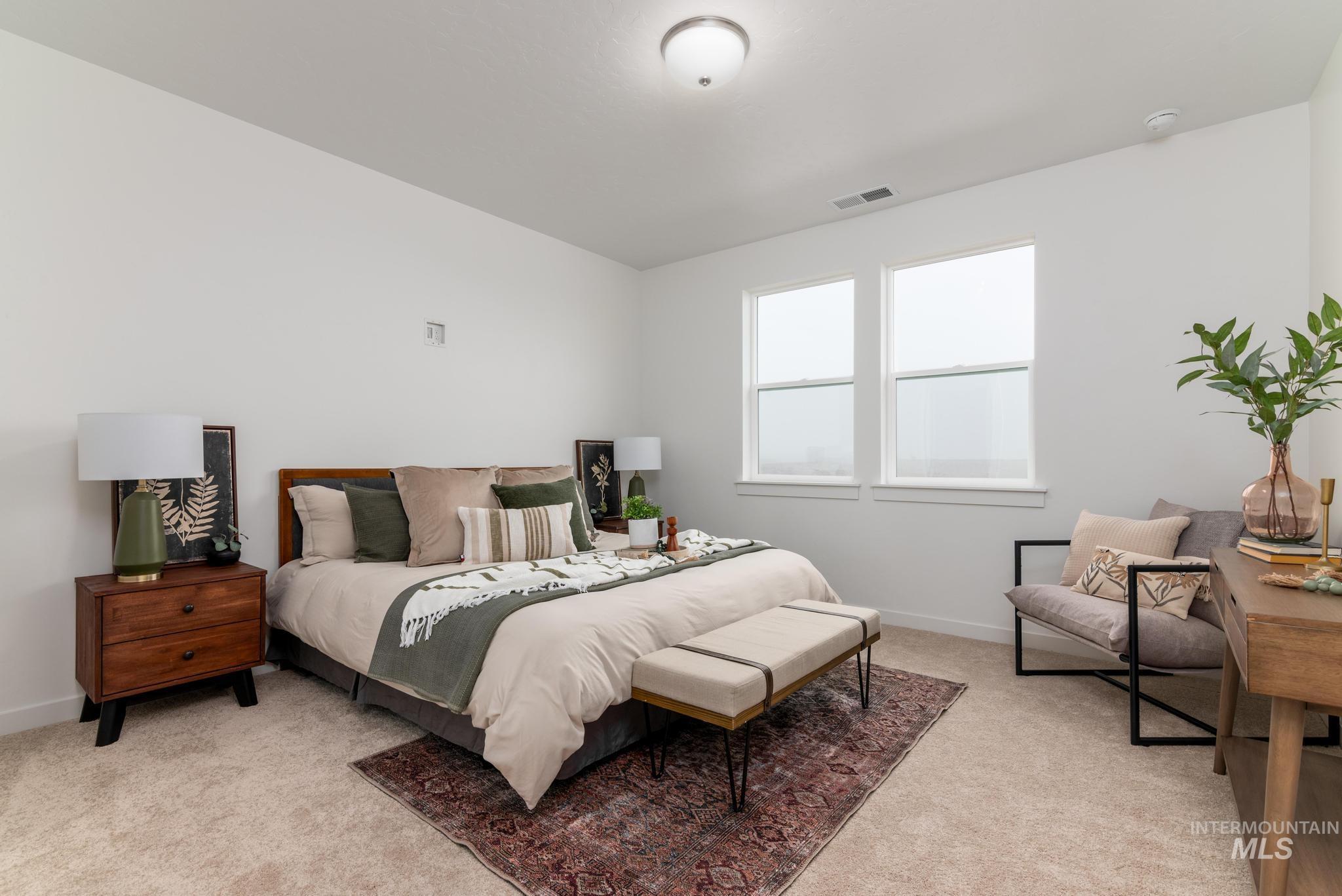 Bedroom featuring light colored carpet and baseboards