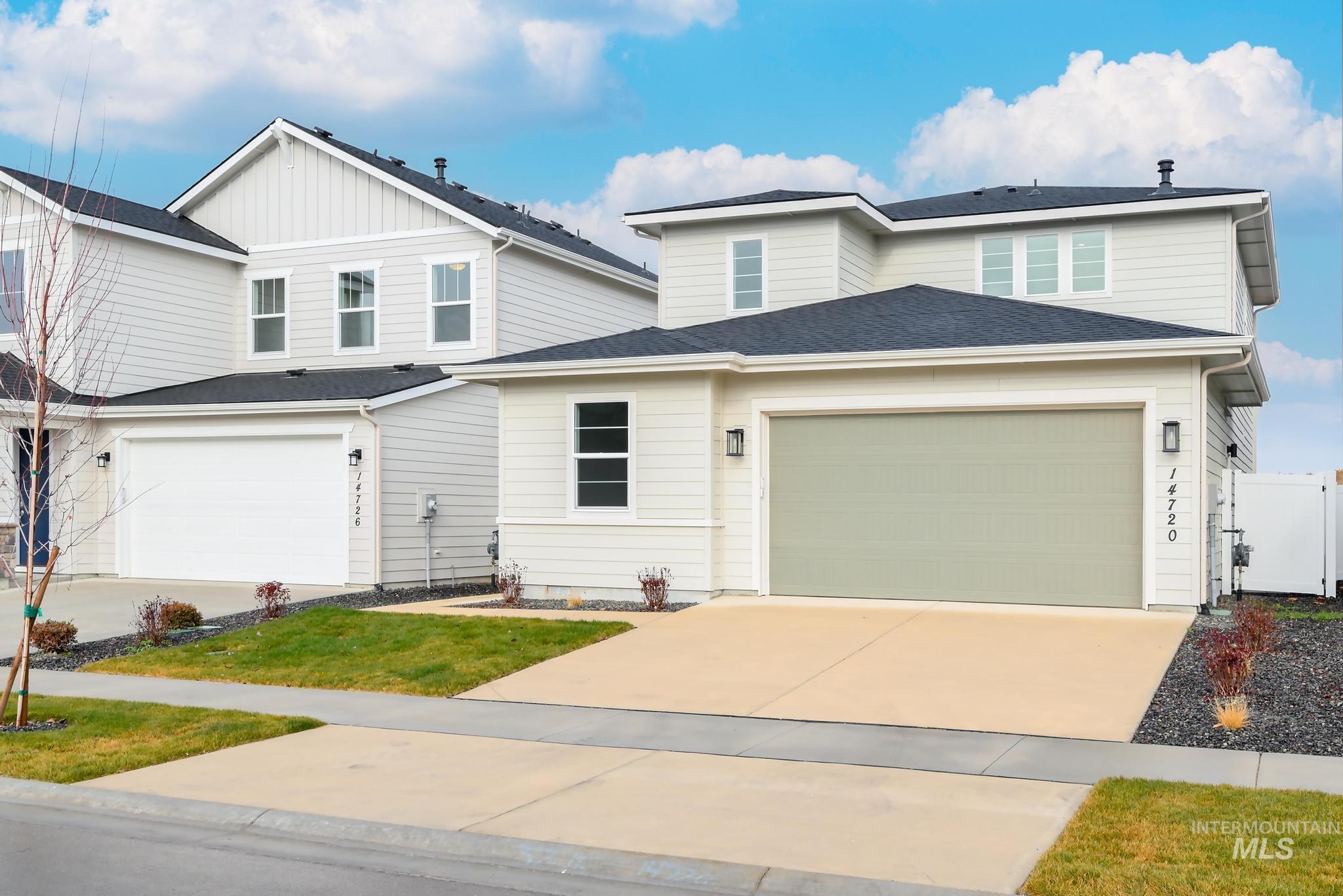View of front of house featuring a garage, concrete driveway, and roof with shingles