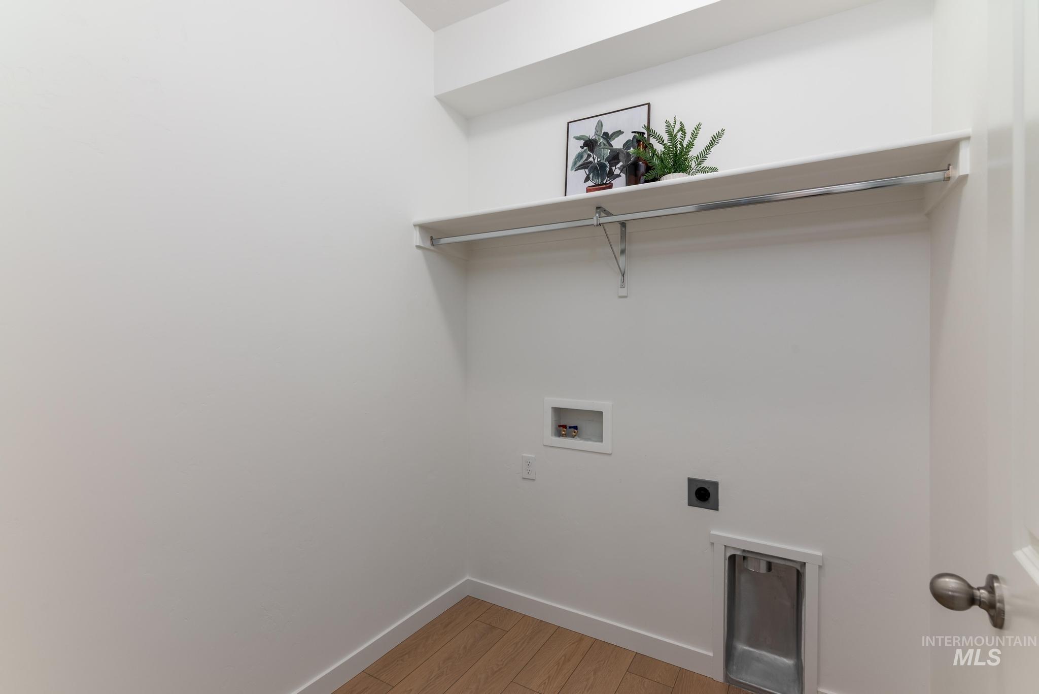 Washroom featuring light wood-style floors, electric dryer hookup, and washer hookup