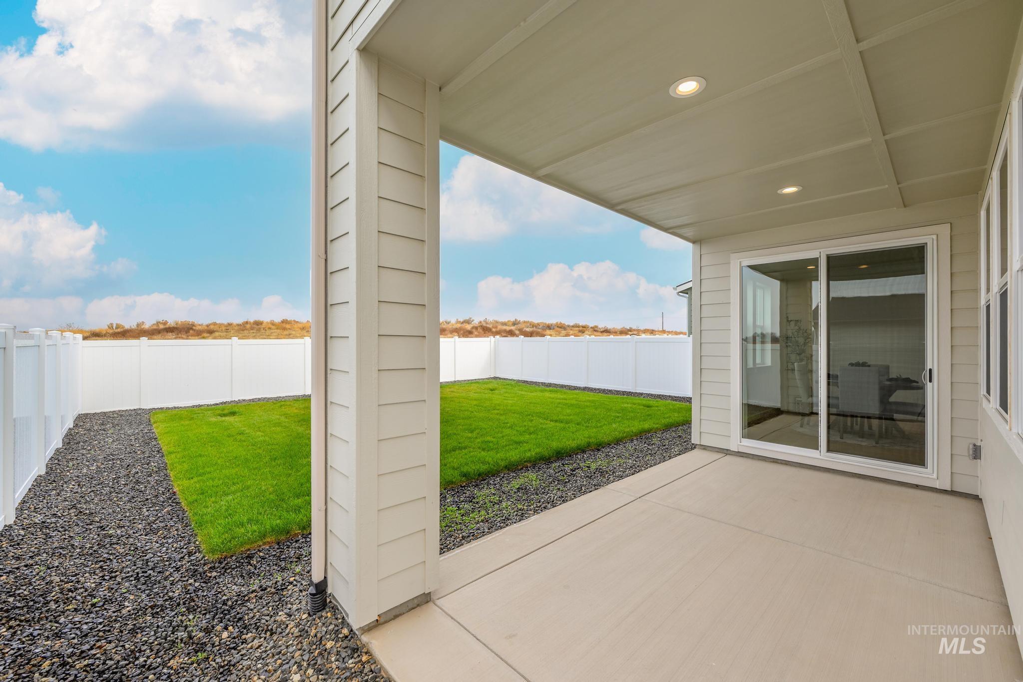 Fenced backyard with a patio area