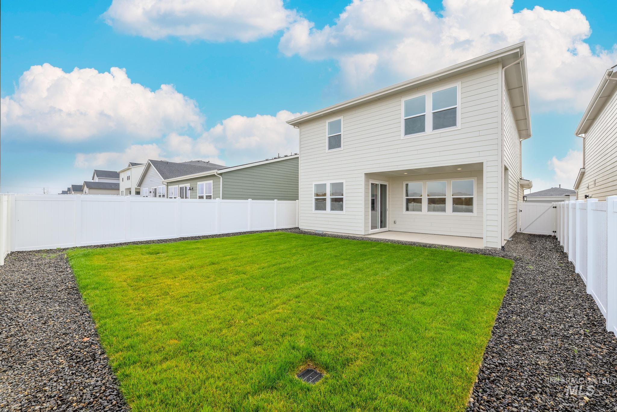 Rear view of property featuring a patio area and a fenced backyard