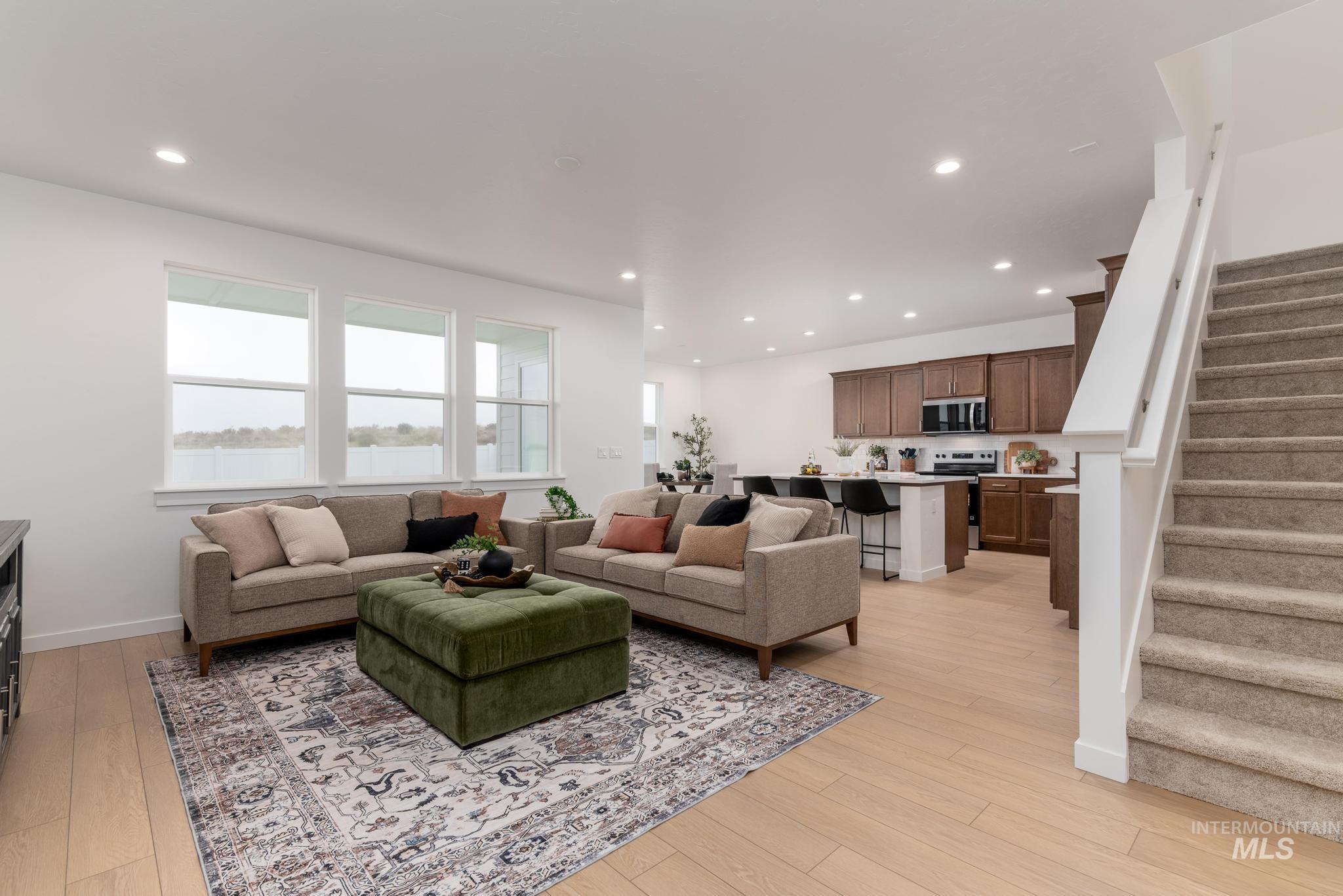 Living area featuring stairway, recessed lighting, and light wood-type flooring