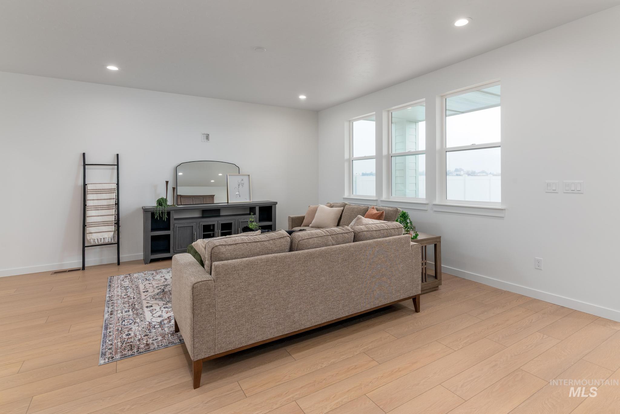Living area featuring light wood-style floors and recessed lighting