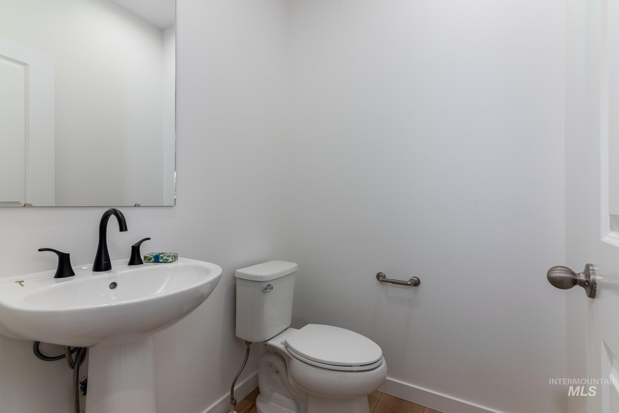 Bathroom with toilet and baseboards