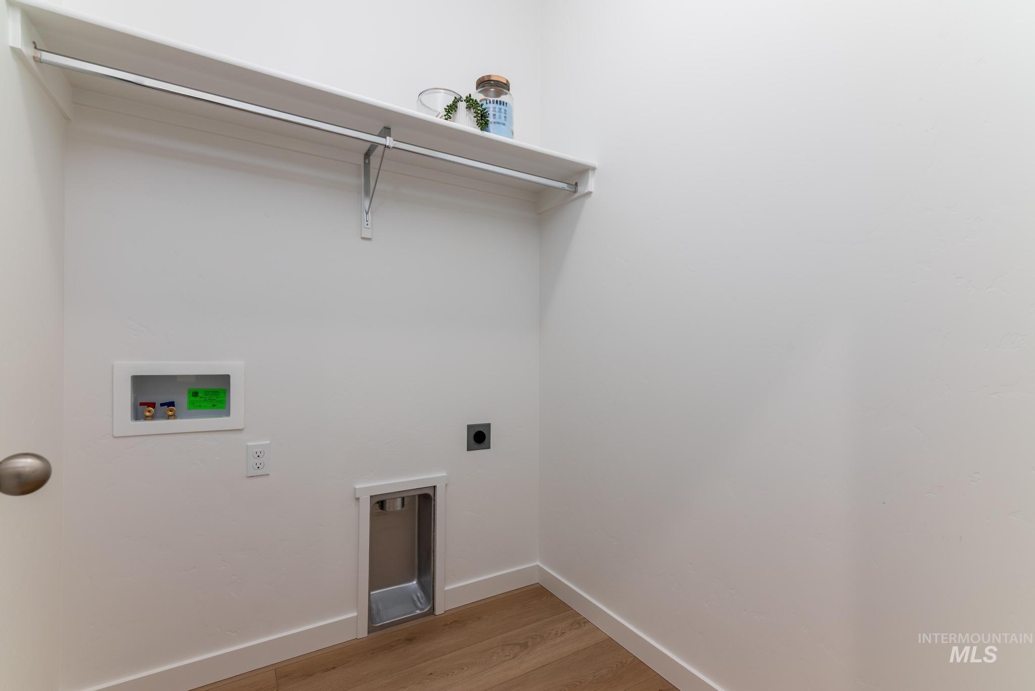 Laundry room featuring electric dryer hookup, light wood-type flooring, and hookup for a washing machine