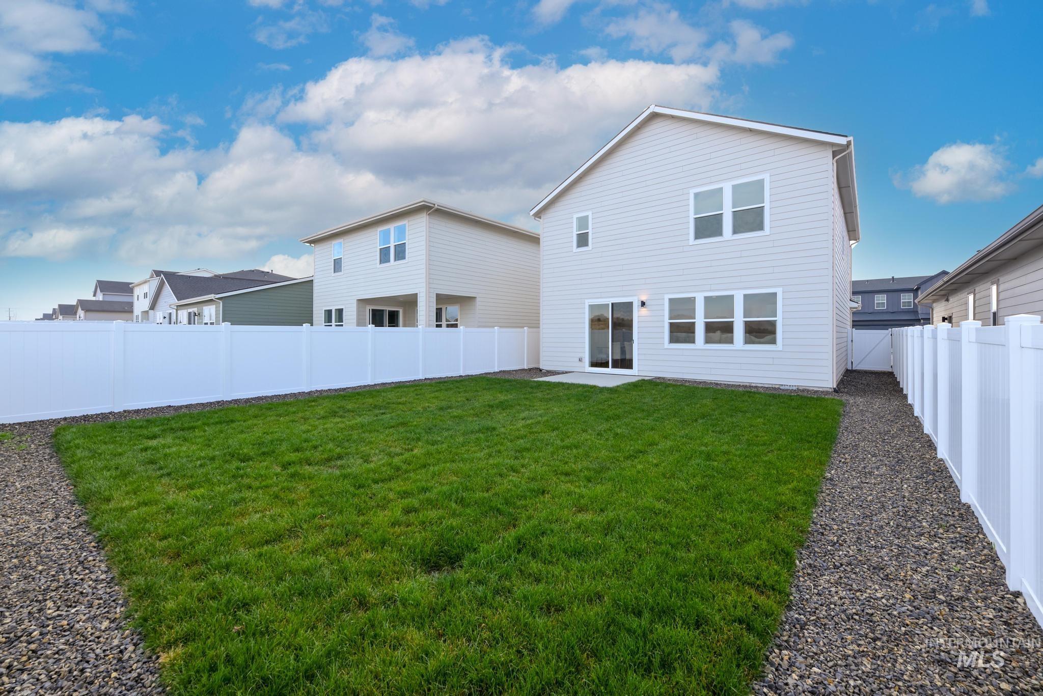 Rear view of house featuring a fenced backyard and a patio area