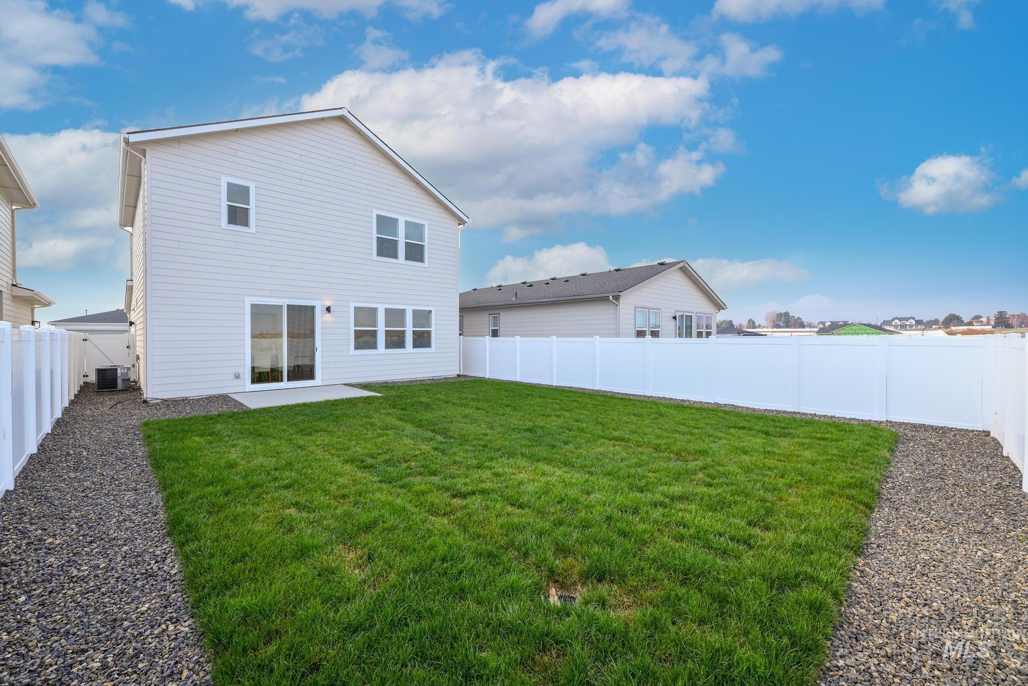 Back of property with a patio and a fenced backyard