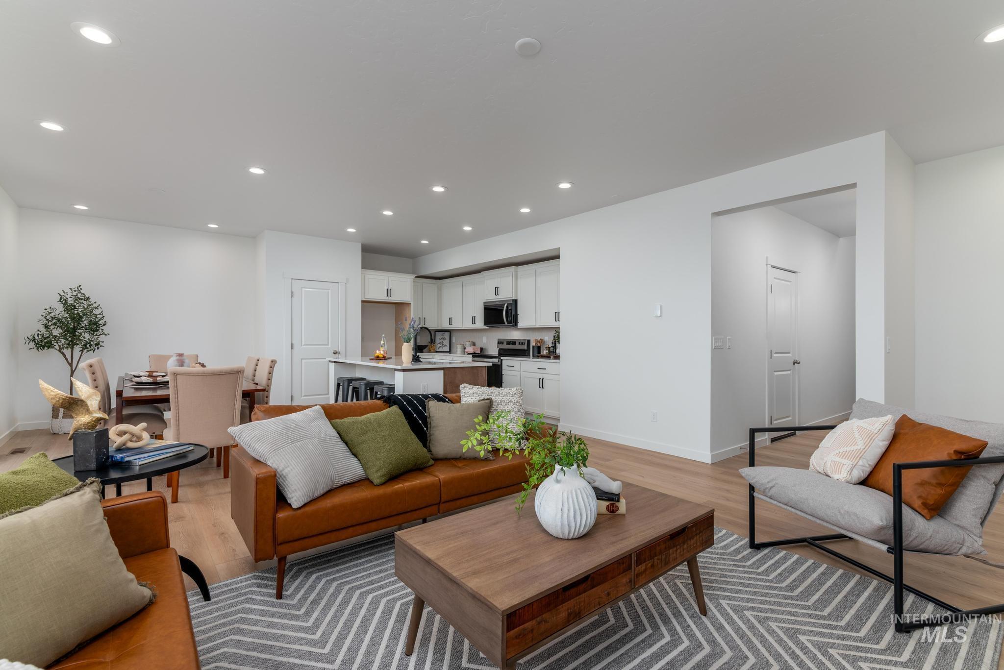 Living room with recessed lighting and light wood-style floors