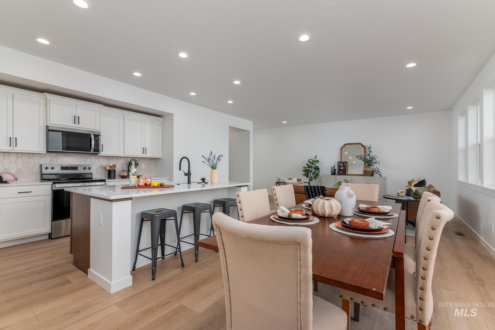 Dining room featuring light wood-style flooring and recessed lighting